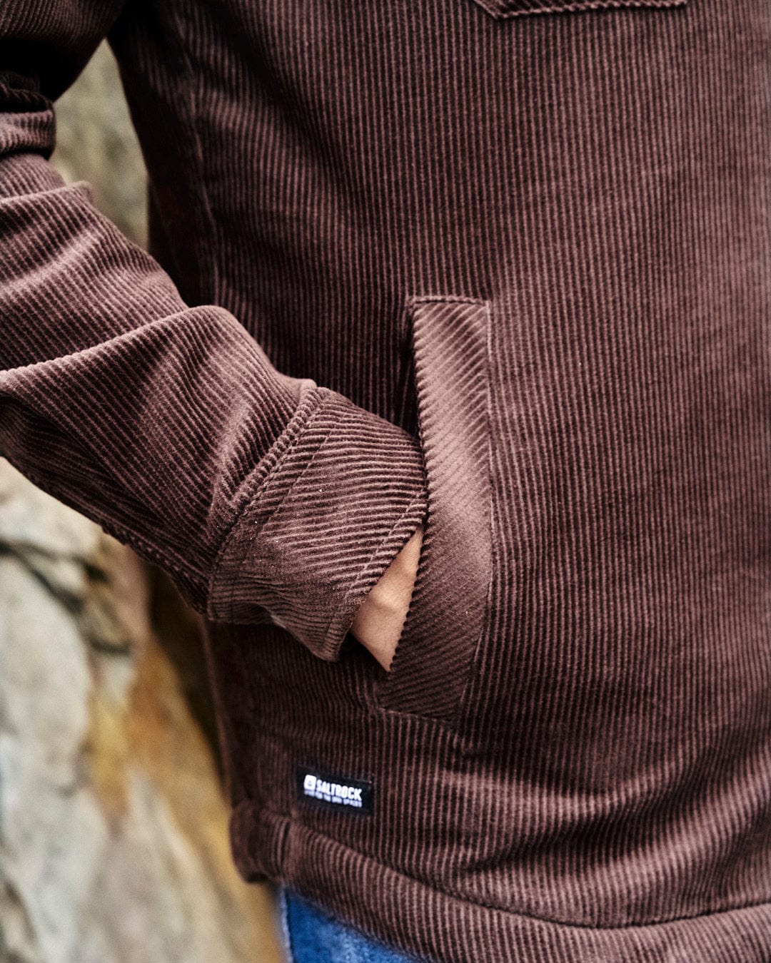 A man displaying style and comfort in his Saltrock Zeke - Mens Cord Borg Lined Shacket - Dark Brown.