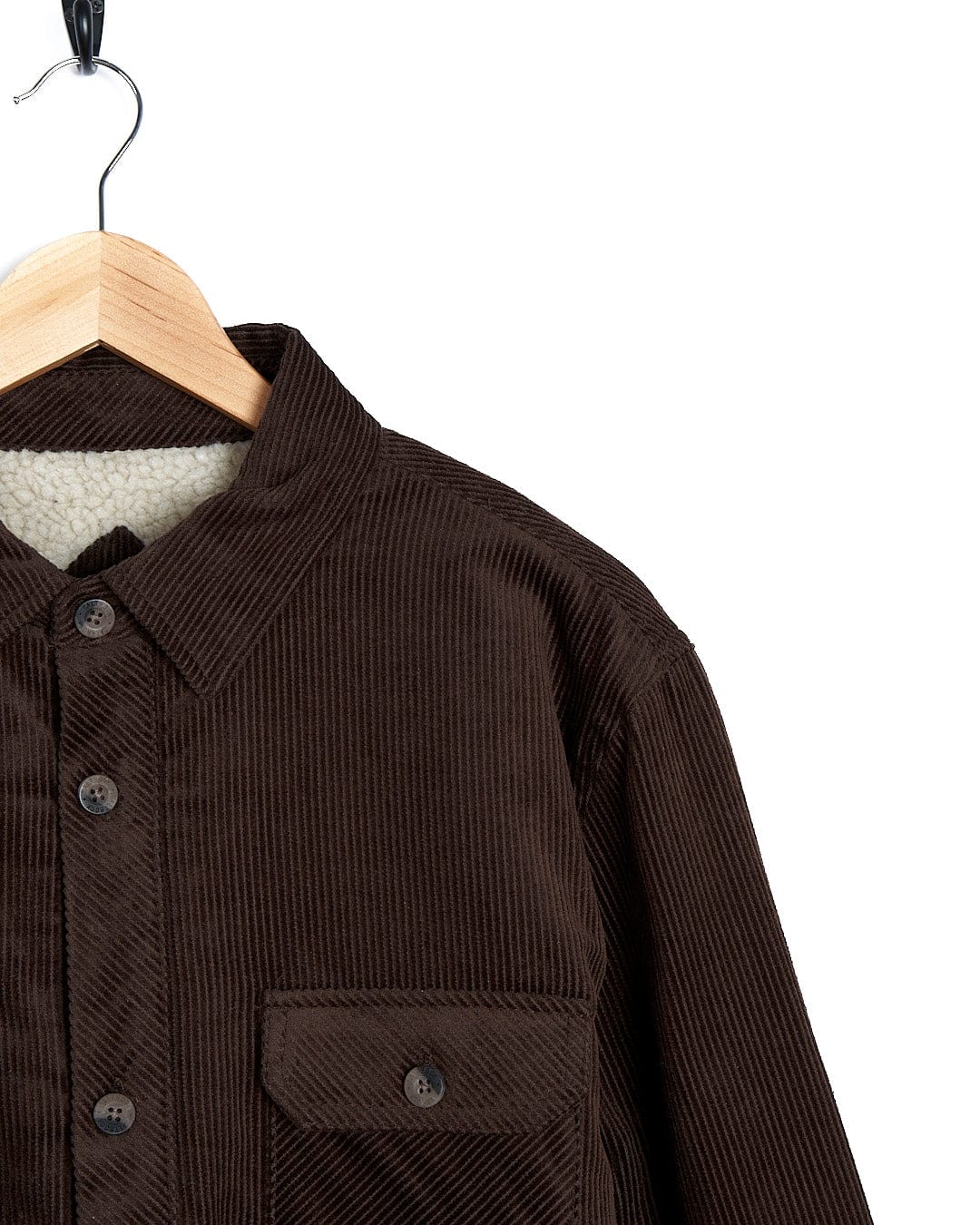 A comfortable and stylish Zeke - Mens Cord Borg Lined Shacket - Dark Brown shirt hanging on a hanger. (Brand Name: Saltrock)