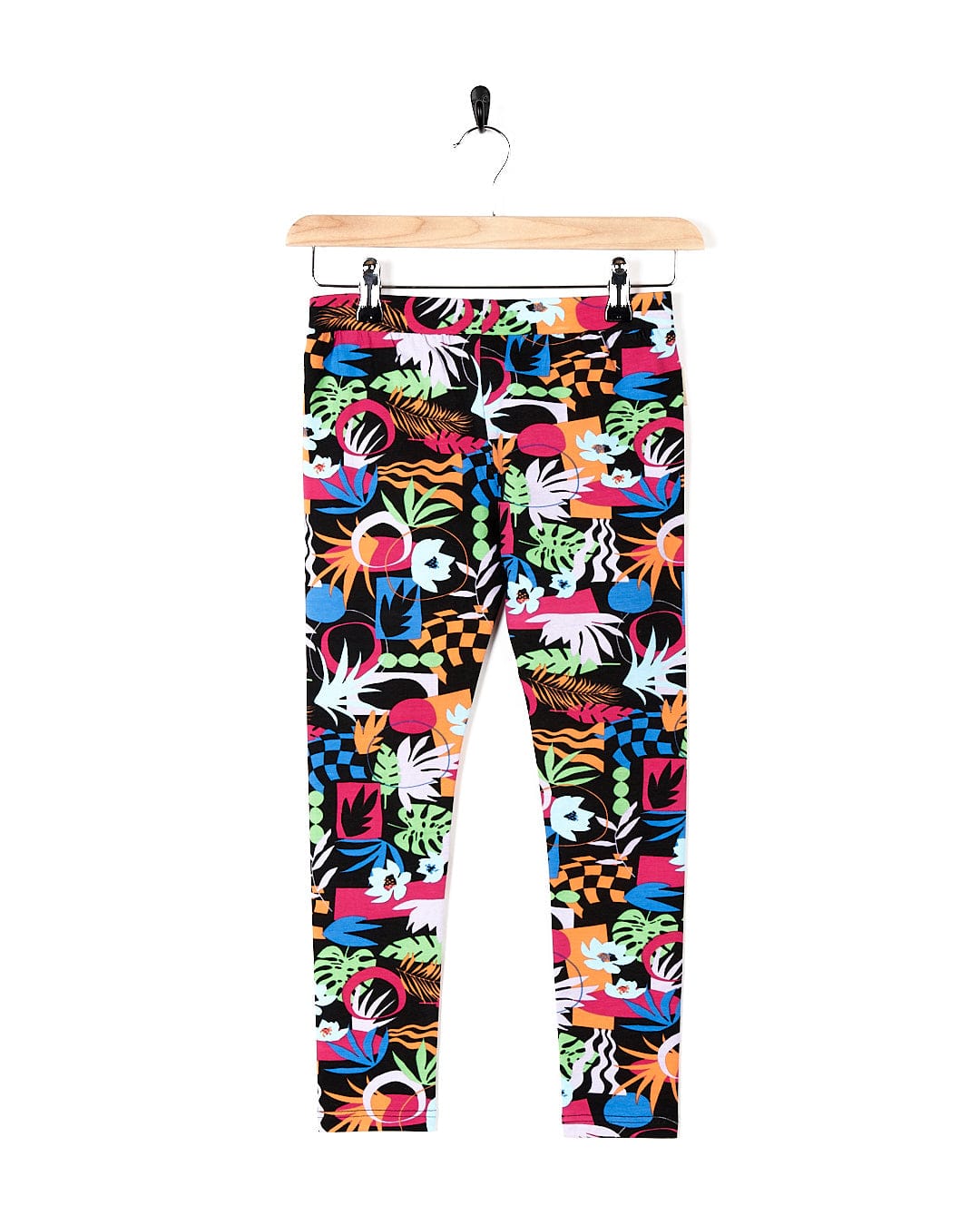A girl's Zephyr - Kids Leggings - Black with a tropical print by Saltrock.