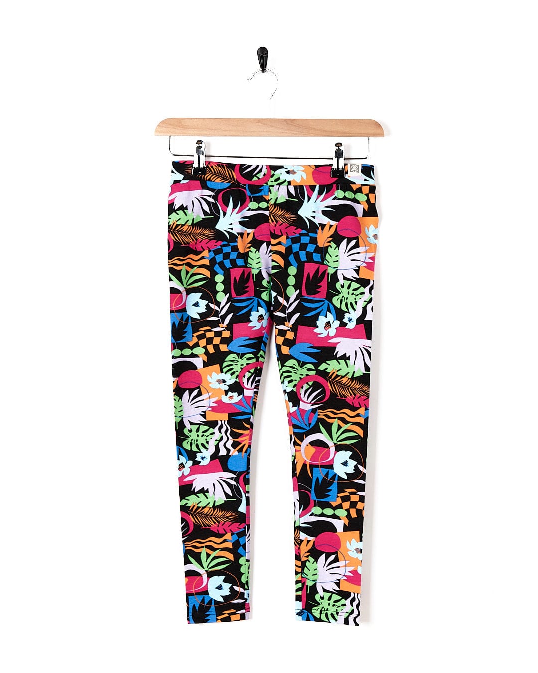 A pair of Saltrock Zephyr - Kids Leggings - Black with a tropical print.