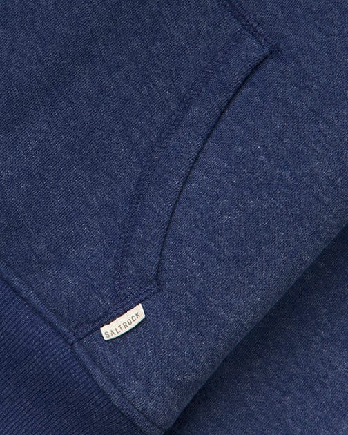 Close-up of the Saltrock Velator Women's Borg Lined Hoodie in blue, featuring a soft peached finish, visible pouch pocket, and a small branded "Saltrock" fabric tag.
