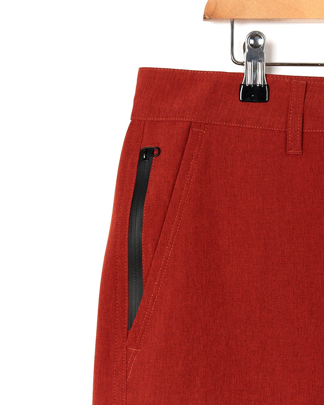 A pair of Saltrock Amphibian II - Mens Boardshort - Red hanging on a hanger.