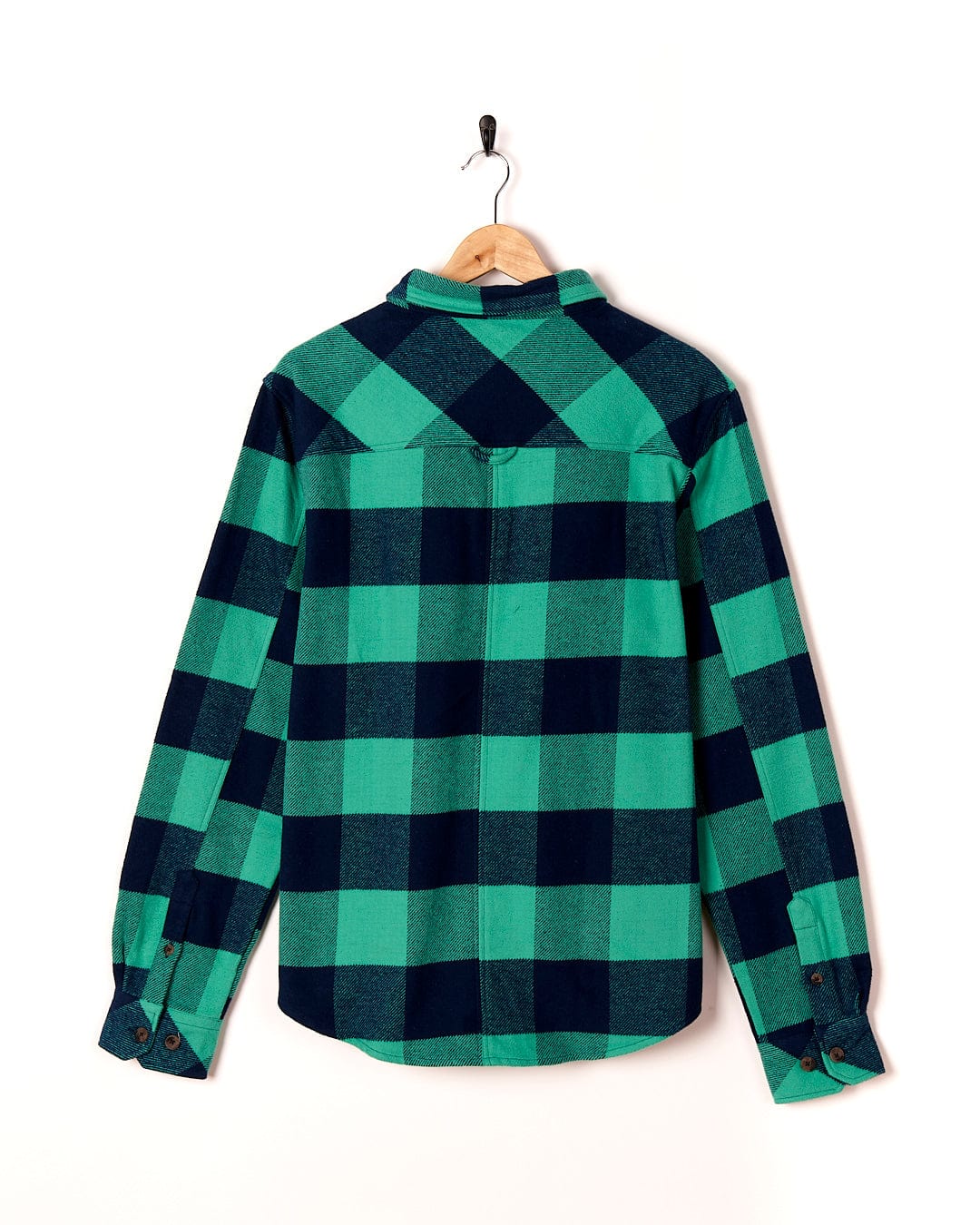 A Saltrock Beale - Mens Heavy Weight Hooded Shirt - Dark Green hanging on a wall.