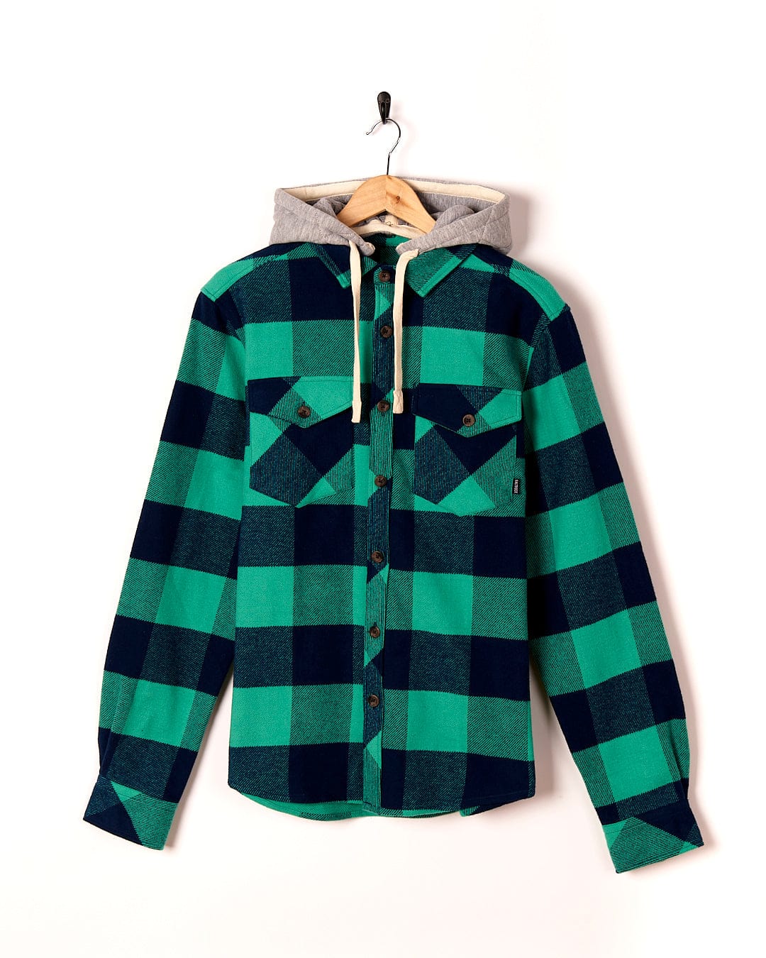 A Saltrock Beale - Mens Heavy Weight Hooded Shirt - Dark Green hanging on a hanger.