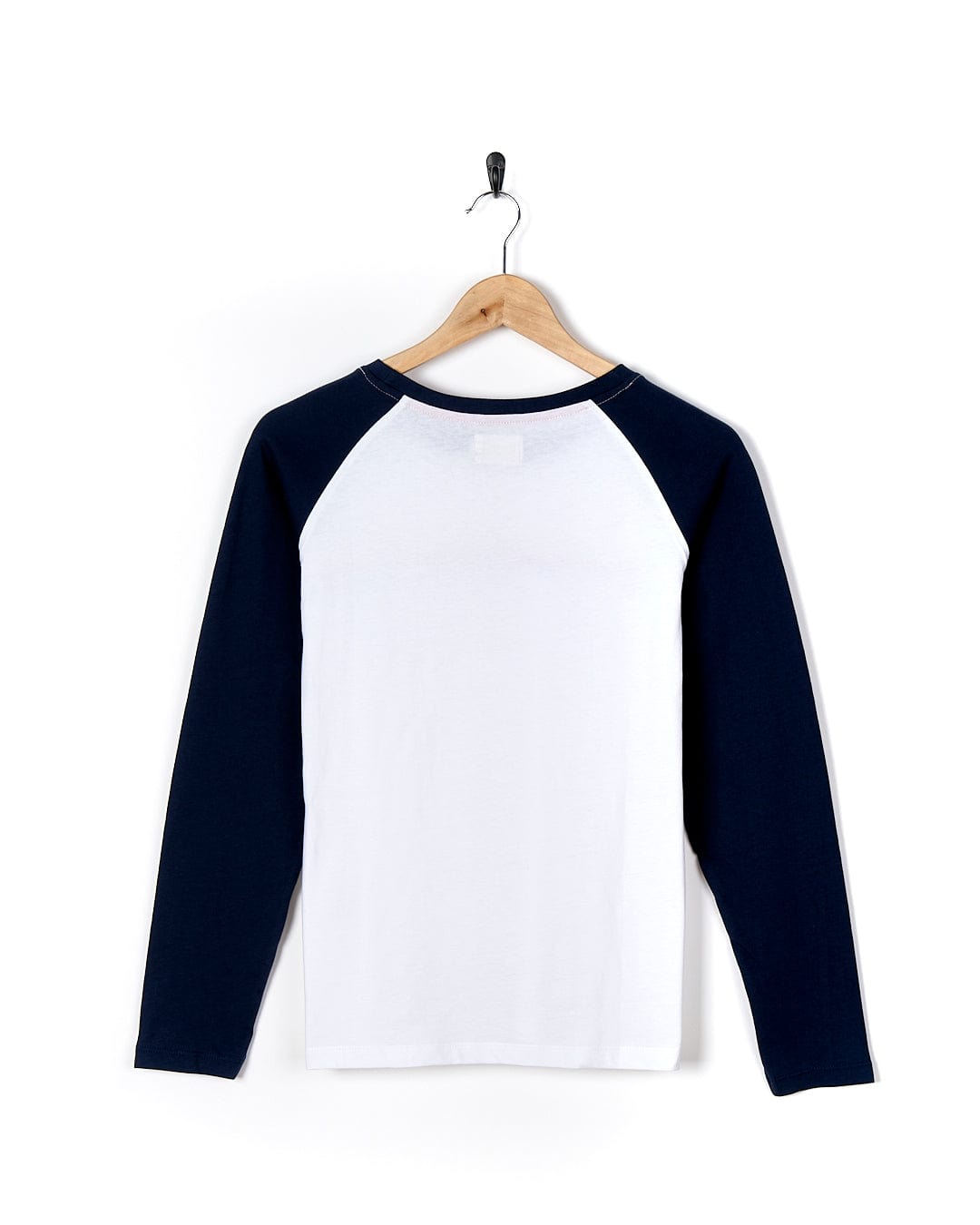 A Celeste Stripe - Womens Long Sleeve Raglan T-Shirt - White/navy by Saltrock hanging on a wall.