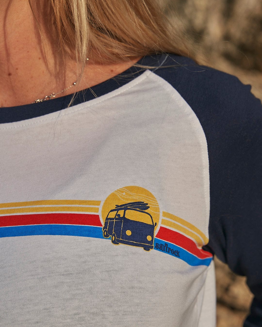 A woman wearing a Saltrock Celeste Stripe - Womens Long Sleeve Raglan T-Shirt - White/navy.