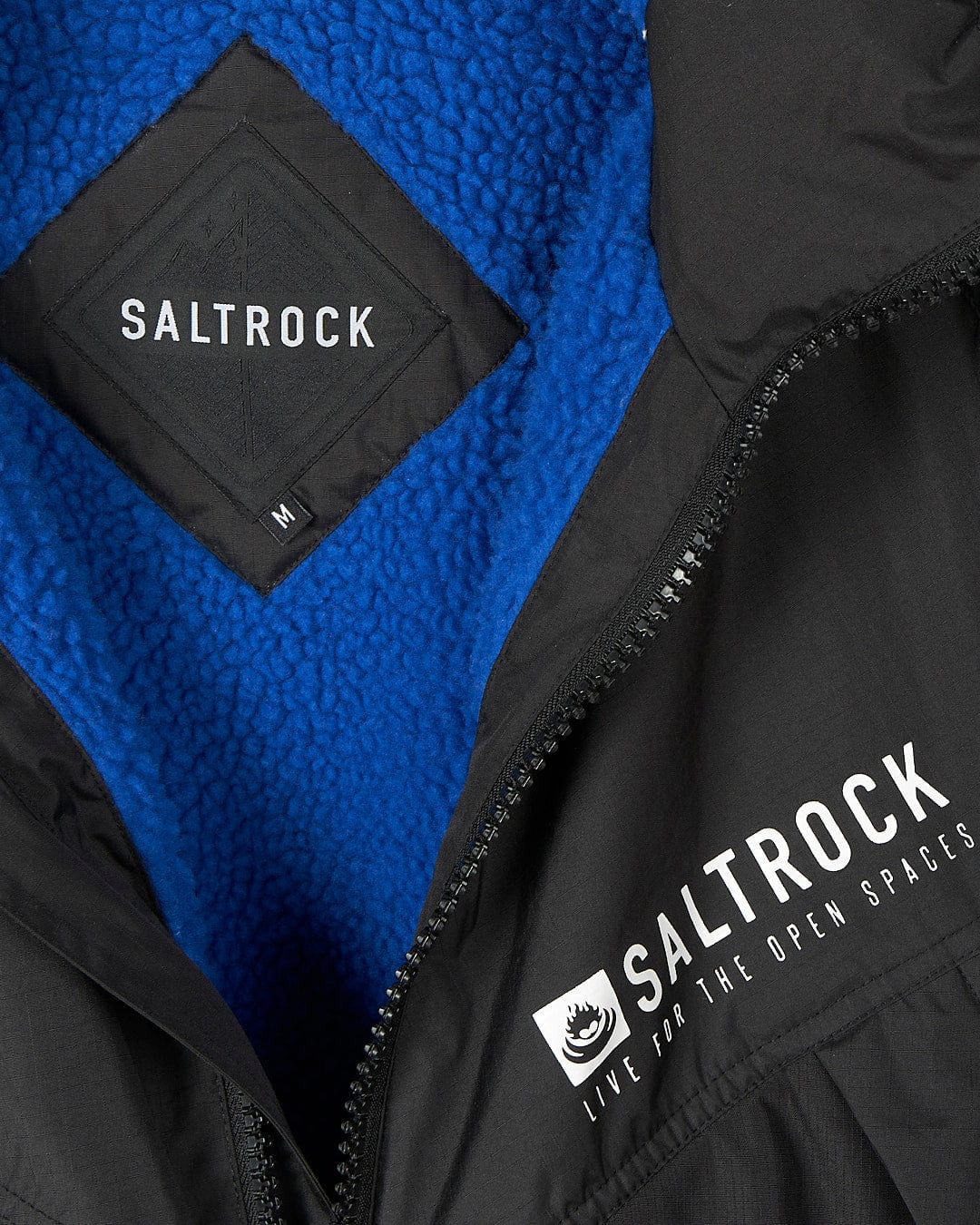 A high-performance Four Seasons - Waterproof Changing Robe - Black/Blue jacket with the brand name Saltrock on it.