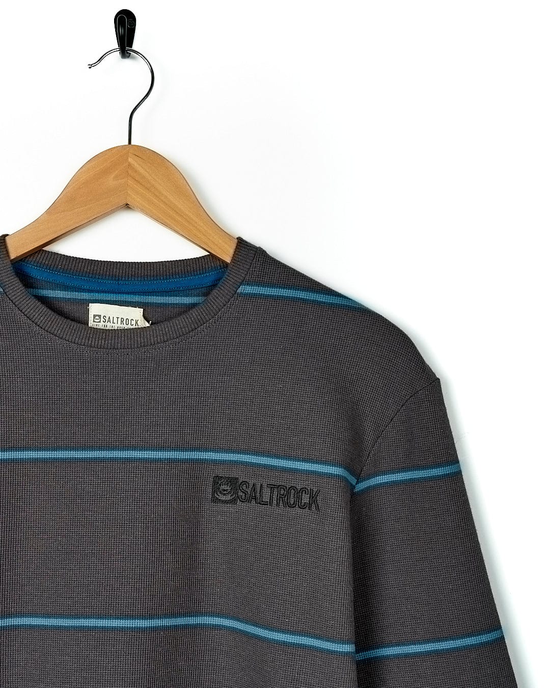 A Saltrock Jasper - Long Sleeve Waffle T-Shirt - Dark Grey hanging on a wooden hanger.