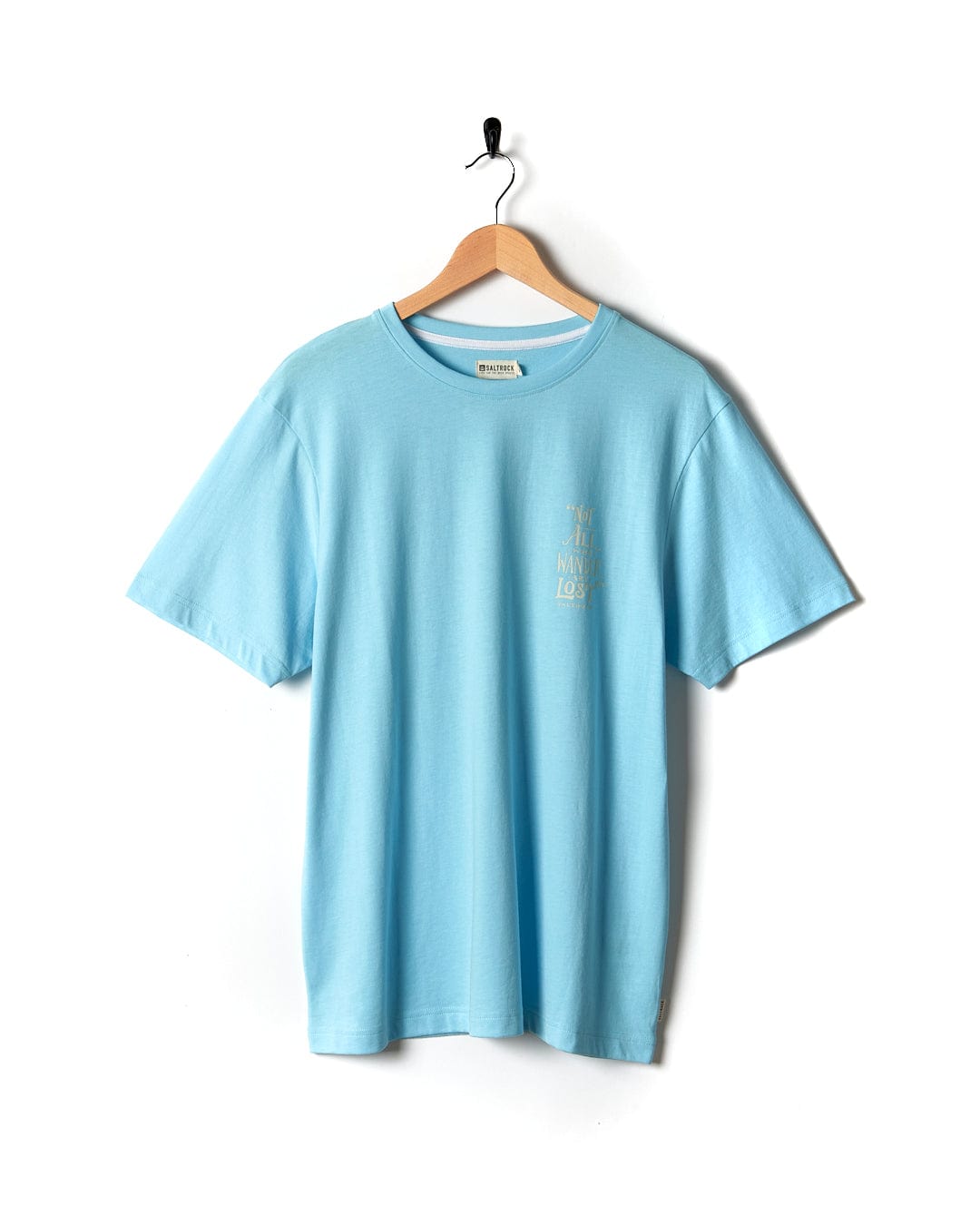 A Lost Ships - Mens Short Sleeve T-Shirt - Light Blue hanging on a wooden hanger.