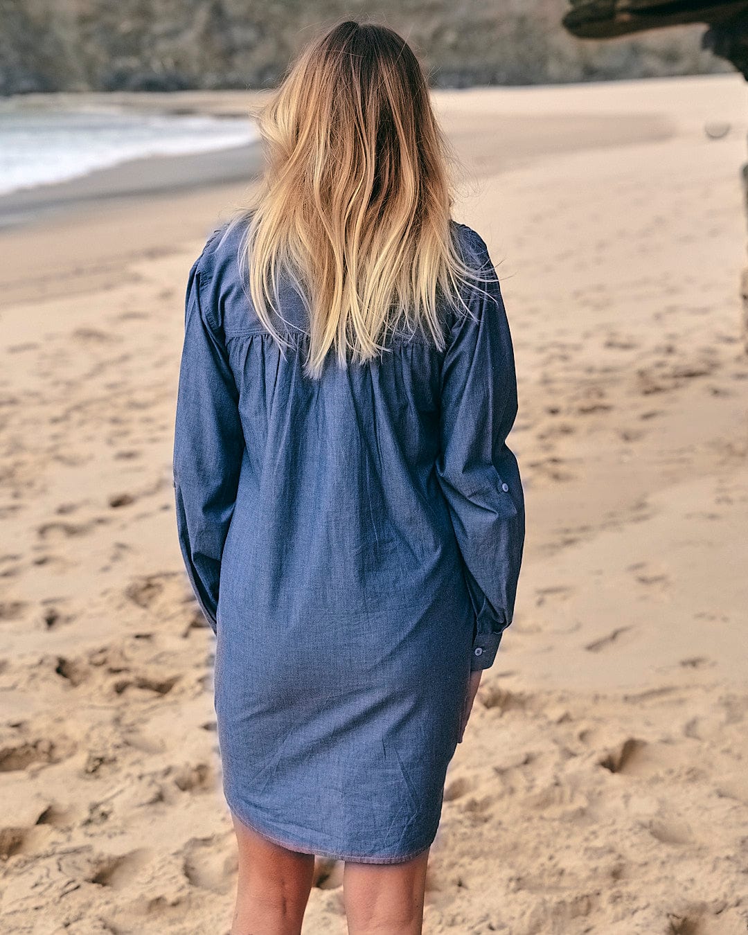 The back of a woman wearing a Saltrock Manina - Womens Beach Shirt - Blue on the beach.