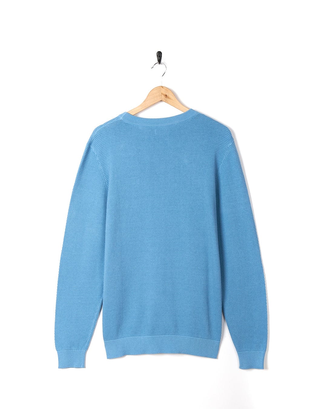 A Saltrock - Moss Mens Washed Knitted Crew - Light Blue sweater hanging on a hanger.
