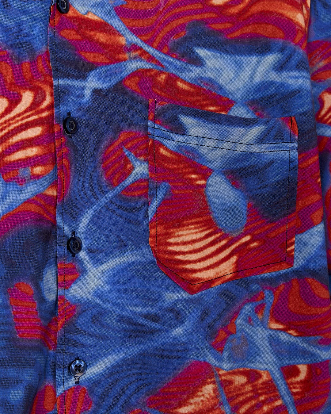This Saltrock - Poolside Mens Short Sleeve Shirt has a bright and fun style, featuring a red, blue and orange pattern.