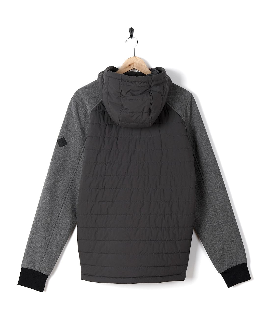 A black and grey Saltrock Purbeck Padded Jacket hanging on a hanger.