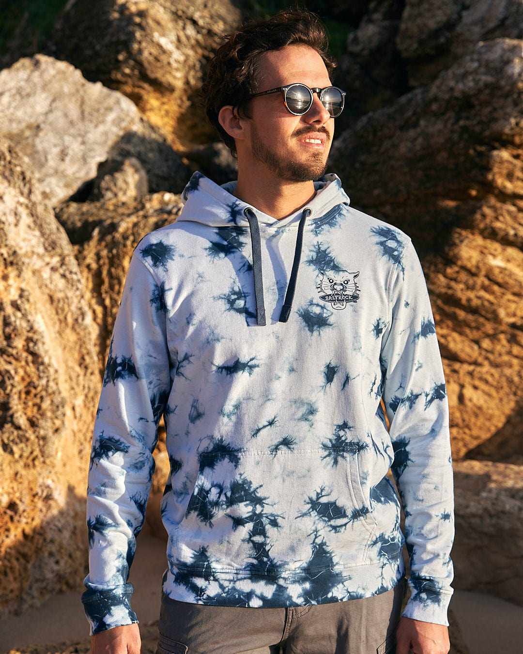 A man wearing sunglasses and a Saltrock Purfect Wave - Mens Tie Dye Pop Hoodie - Light Blue.