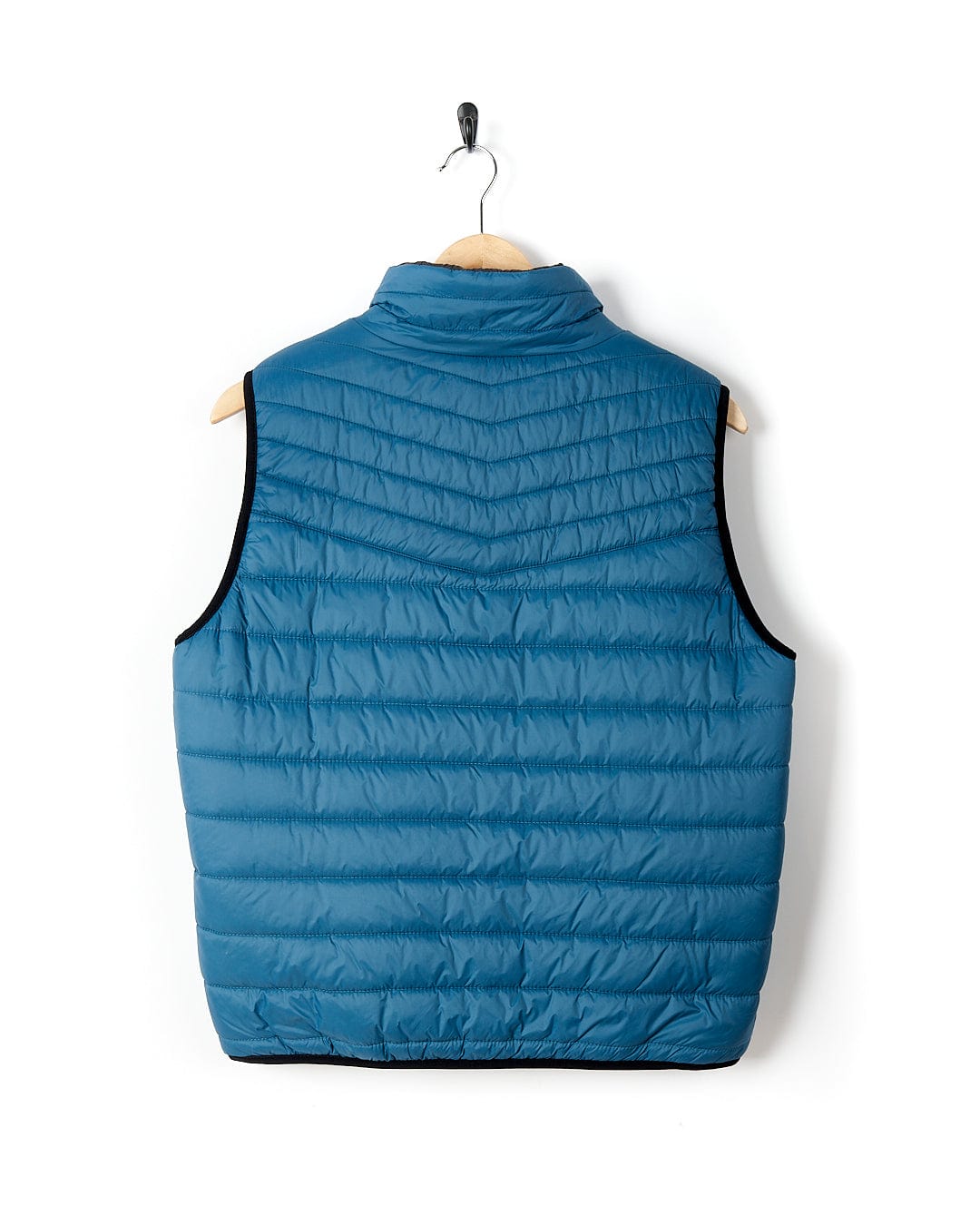 A water-resistant Saltrock blue Ridleys - Womens Reversible Gilet hanging on a wooden hanger.