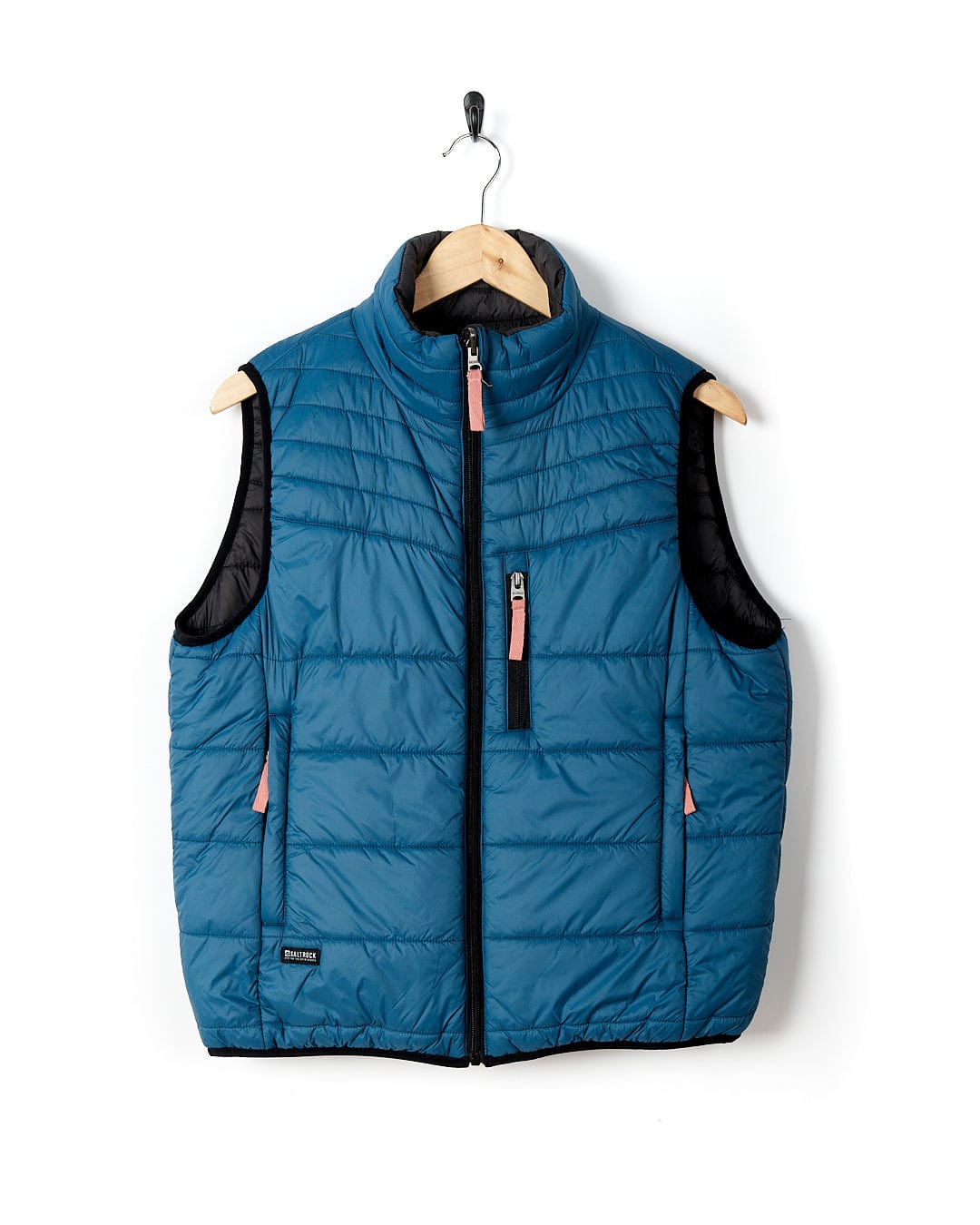 A Saltrock - Womens Ridleys Reversible Gilet - Blue hanging on a wall.