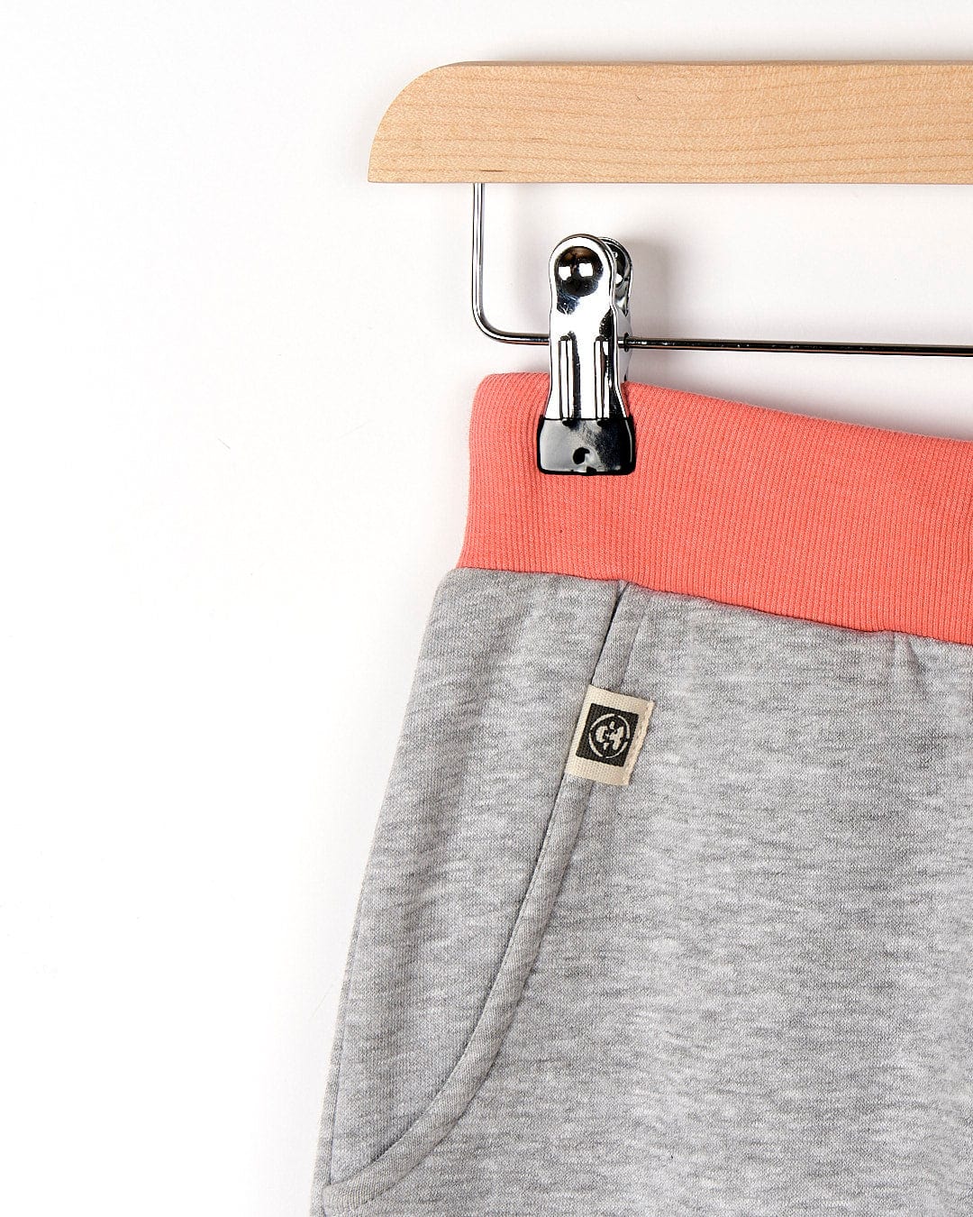 A pair of Saltrock Road Panel - Kids Jogger - Grey sweatpants hanging on a hanger.