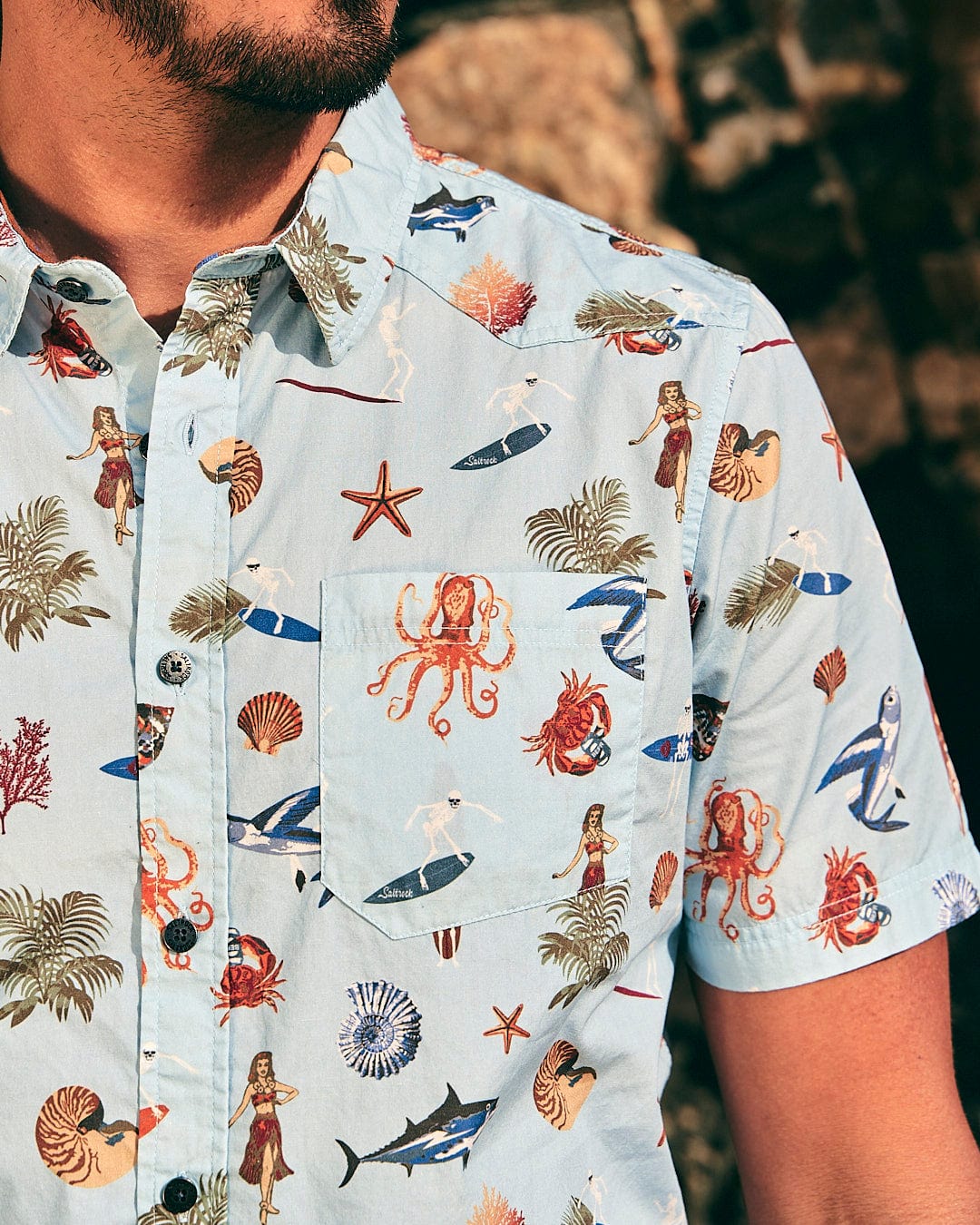 A man wearing a Saltrock Ruan - Mens Washed Short Sleeve Shirt with octopus prints, exuding holiday vibes.