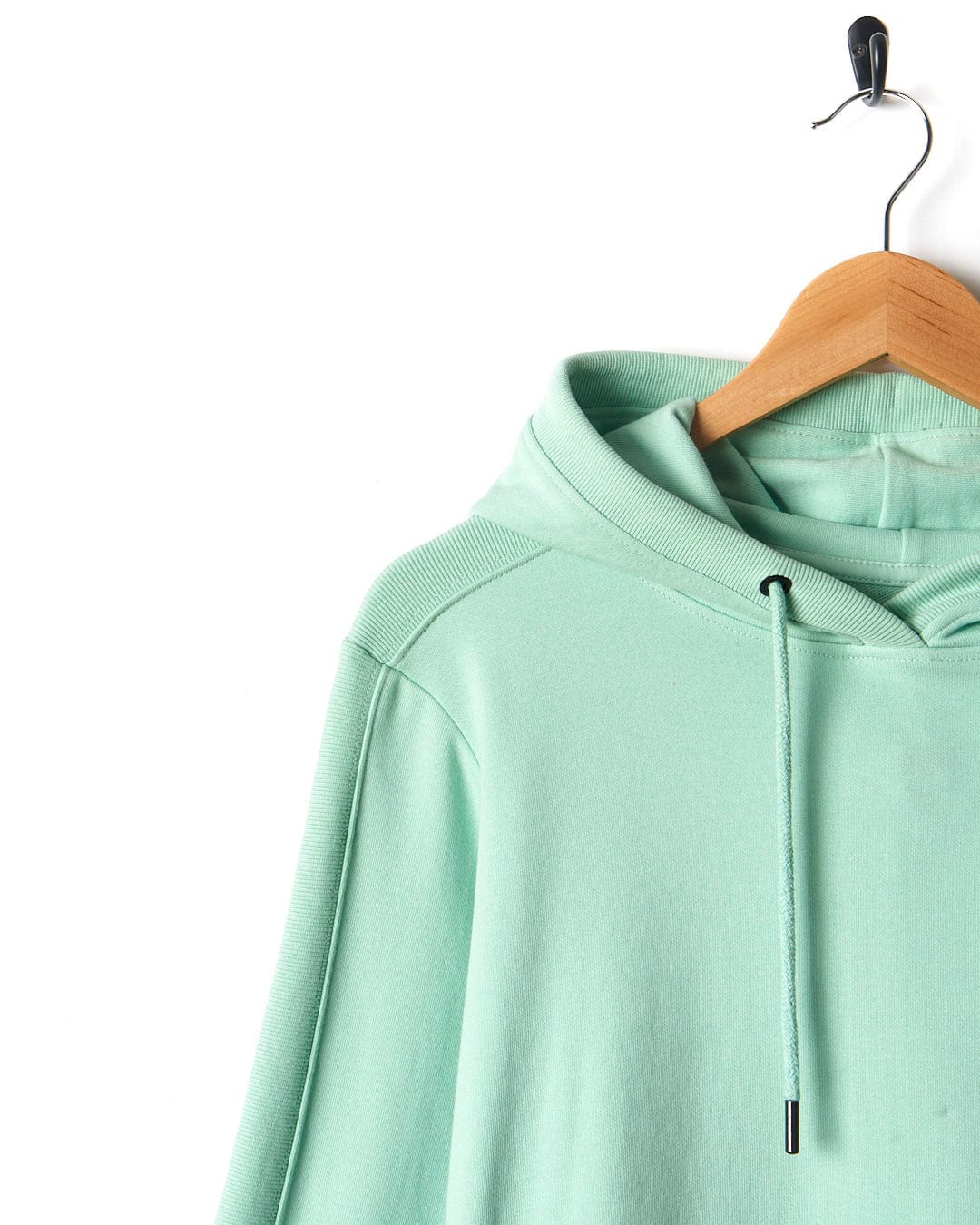 A Shelley - Womens Pop Hoodie - Light Green by Saltrock hanging on a hanger.