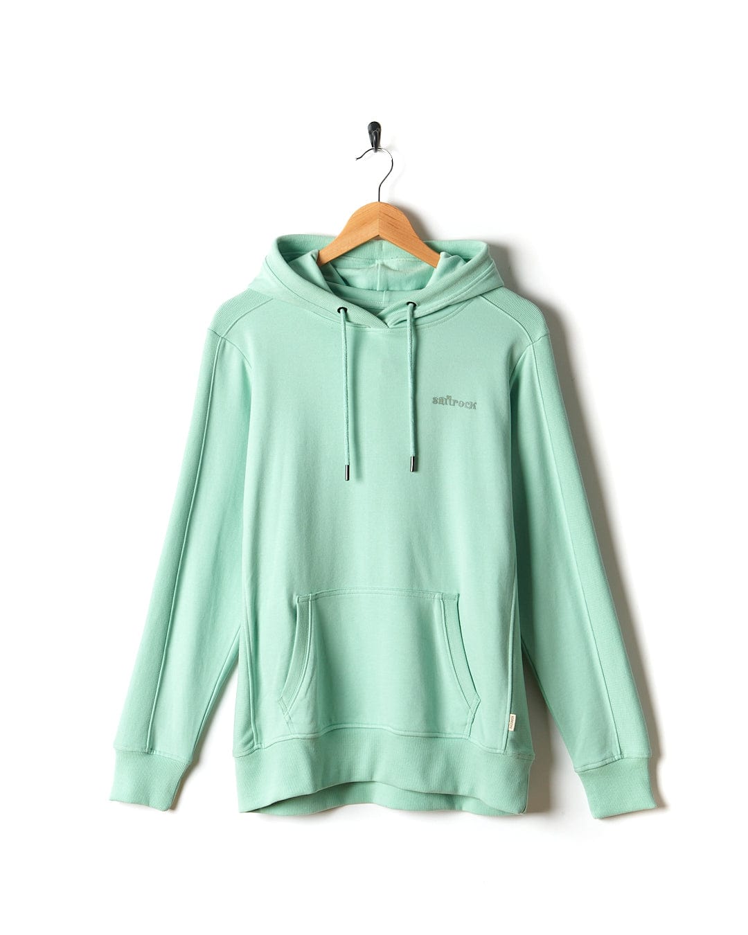 A Shelley - Womens Pop Hoodie - Light Green hangs on a wooden hanger.