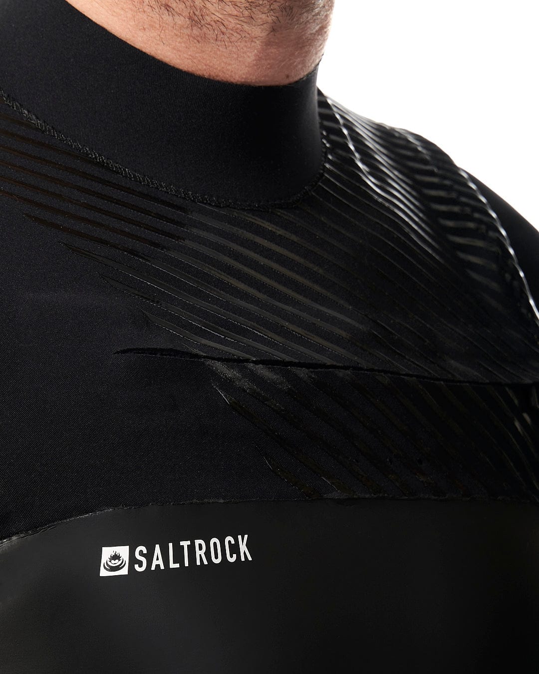 A man wearing the Shockwave - Mens 3/2 Chest Zip Full Wetsuit in Black with the brand name Saltrock on it.