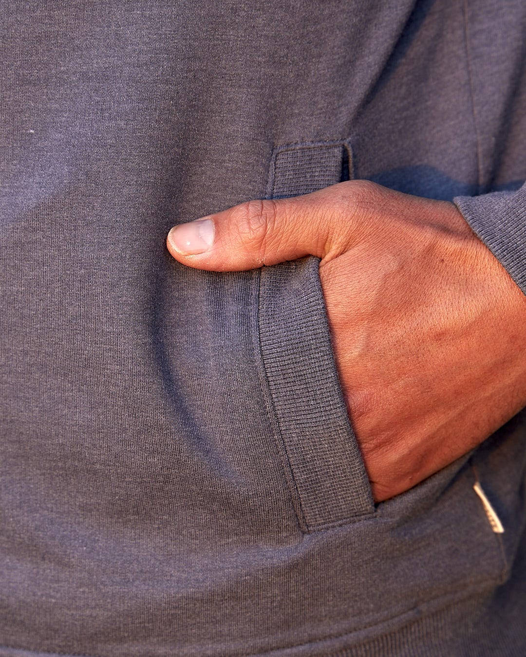 A close up of a man's pocket in a Saltrock Speed - Mens Borg Lined Hoodie - Grey.