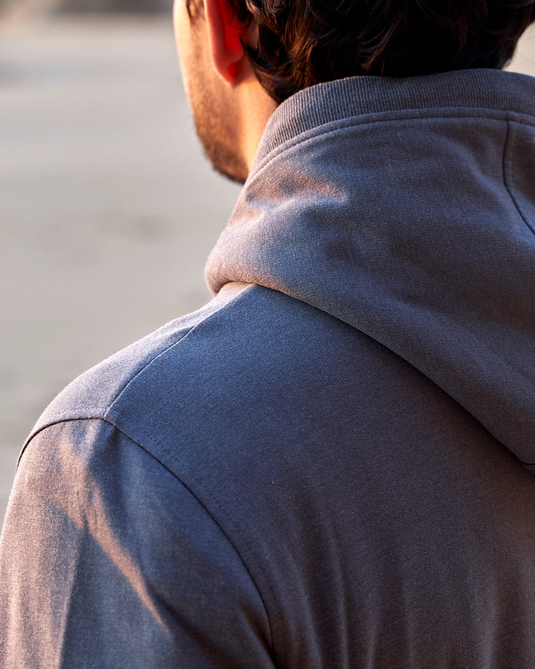 The back of a man wearing a Saltrock Speed - Mens Borg Lined Hoodie - Grey.