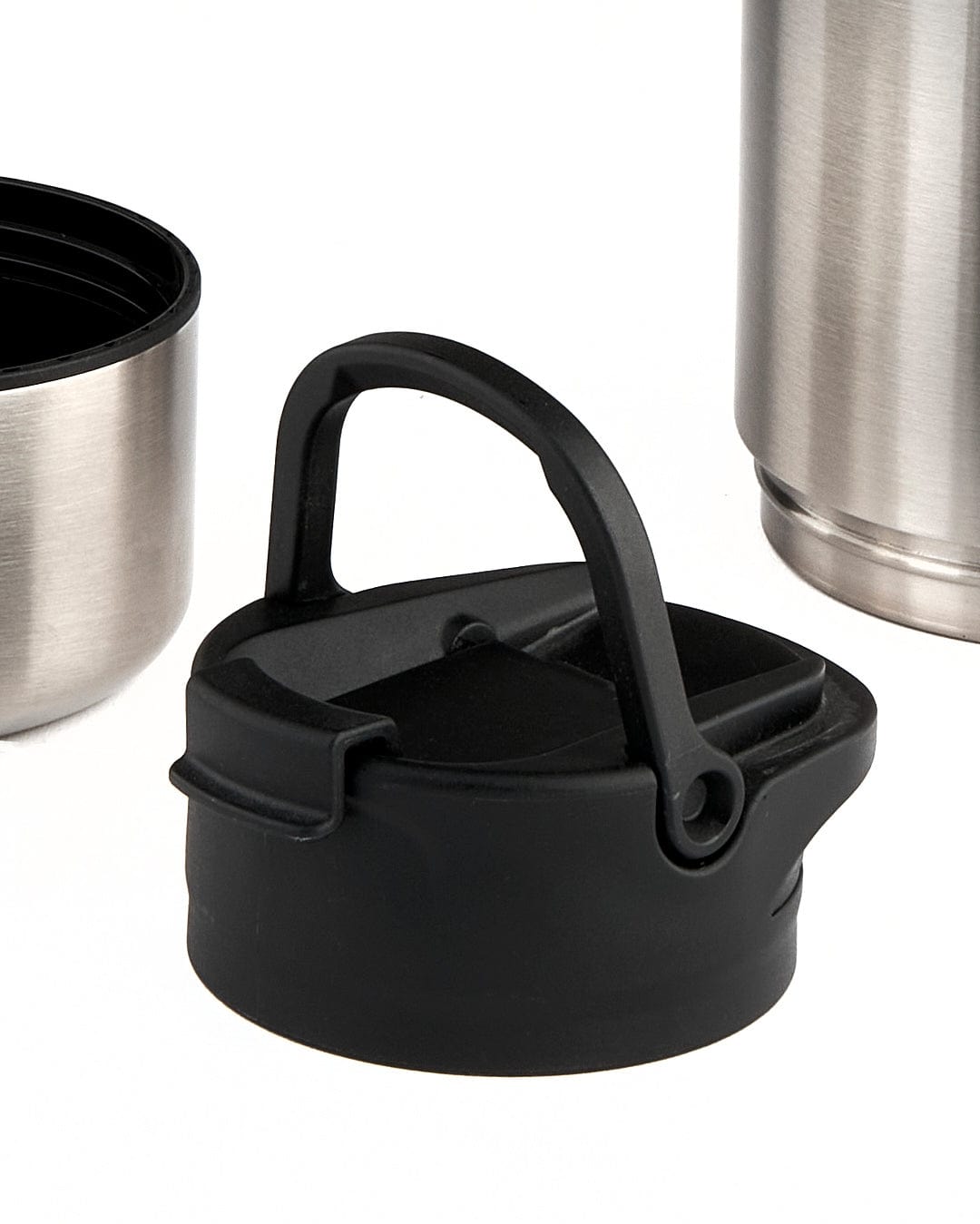 A 32 oz capacity Saltrock Stash Stainless Steel Water Bottle - Silver with a lid beside it.