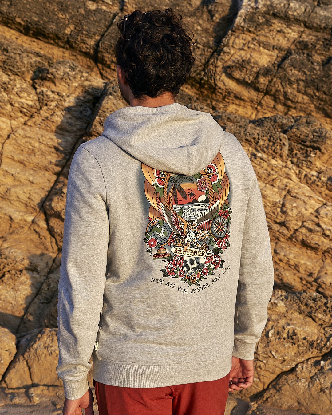 The back of a man wearing a Saltrock Tattoo Island - Mens Zip Hoodie - Grey.