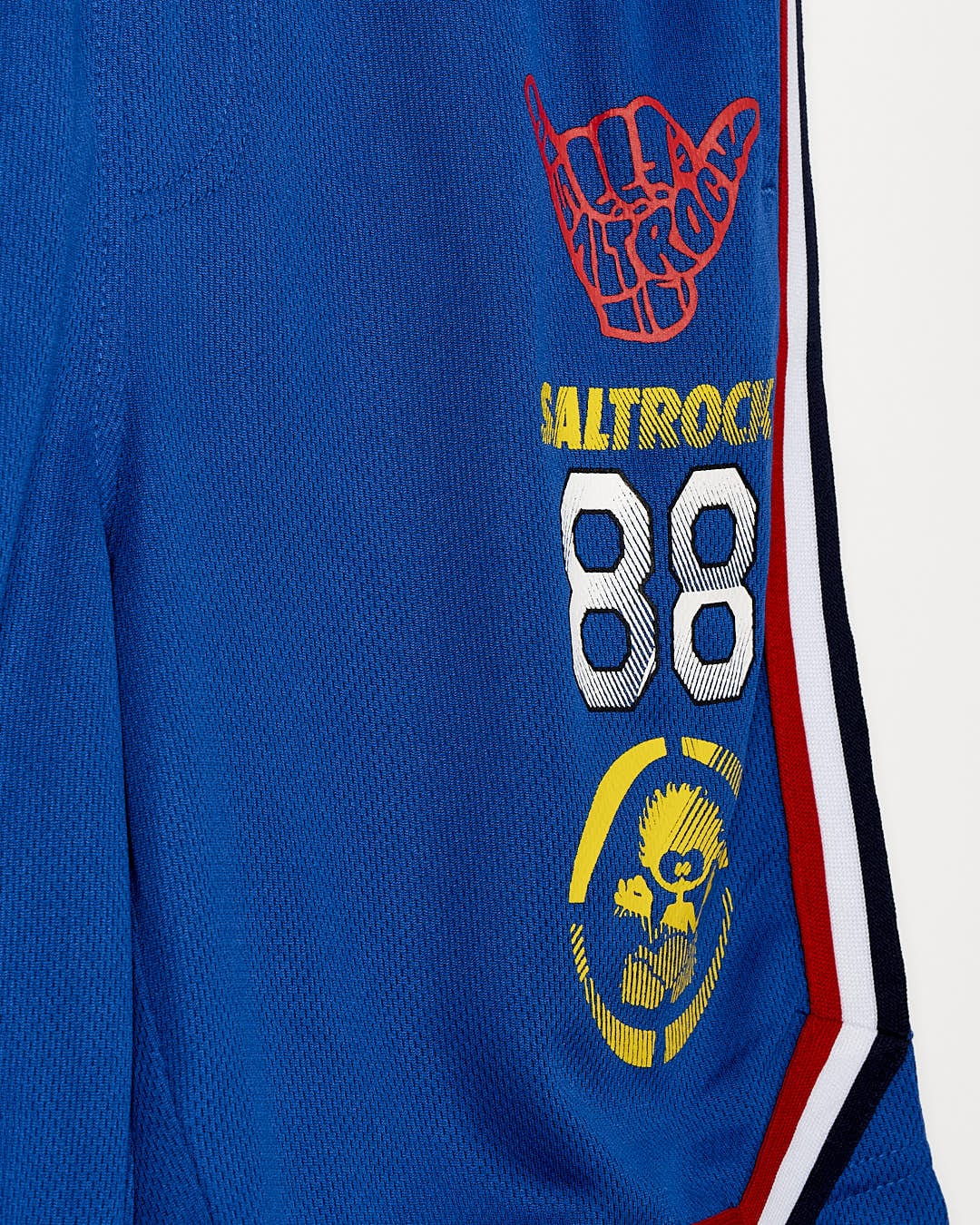 A close up of a Saltrock blue polo shirt with a logo on it.