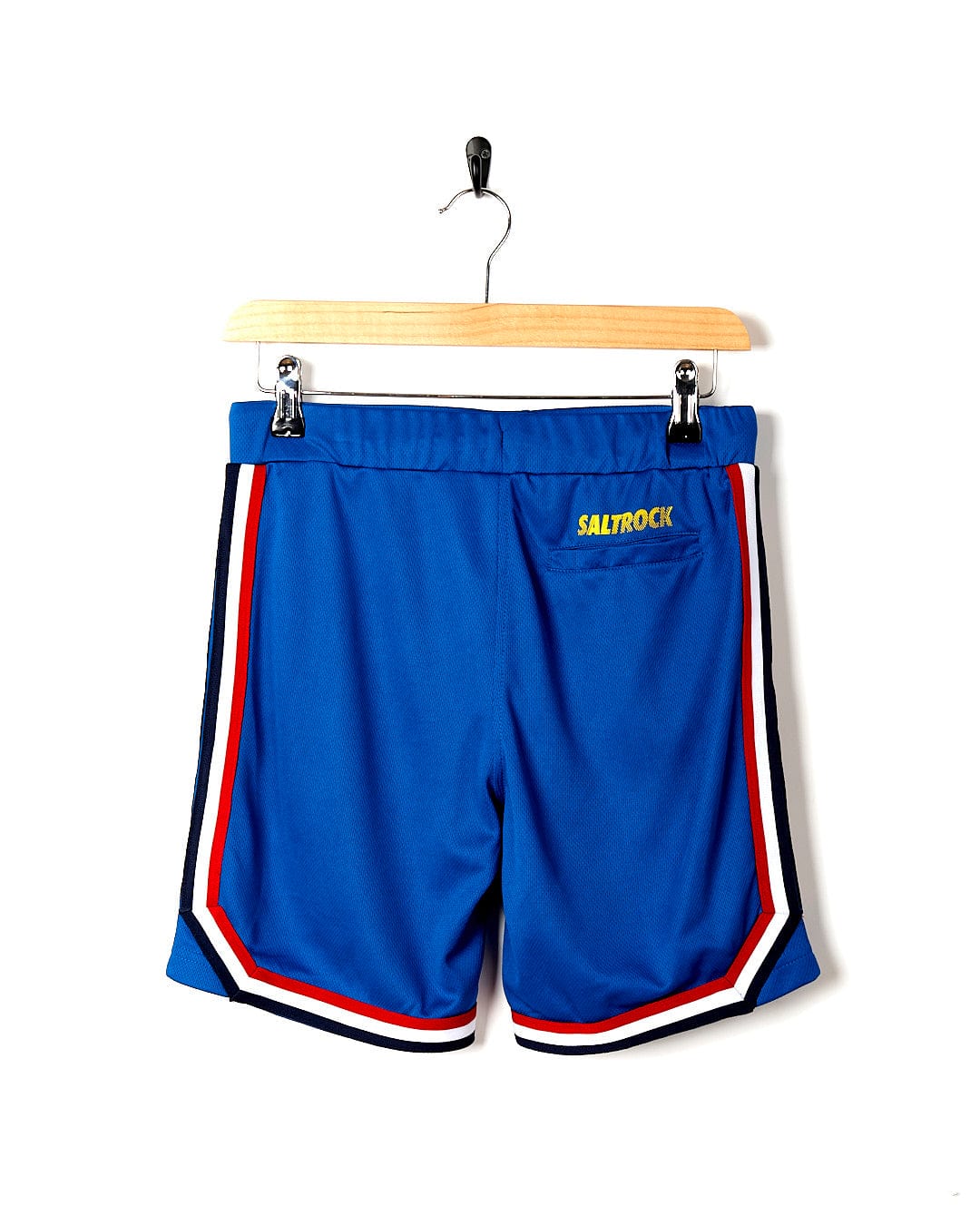 A pair of Saltrock Team - Kids Tech Shorts - Blue hanging on a hanger.