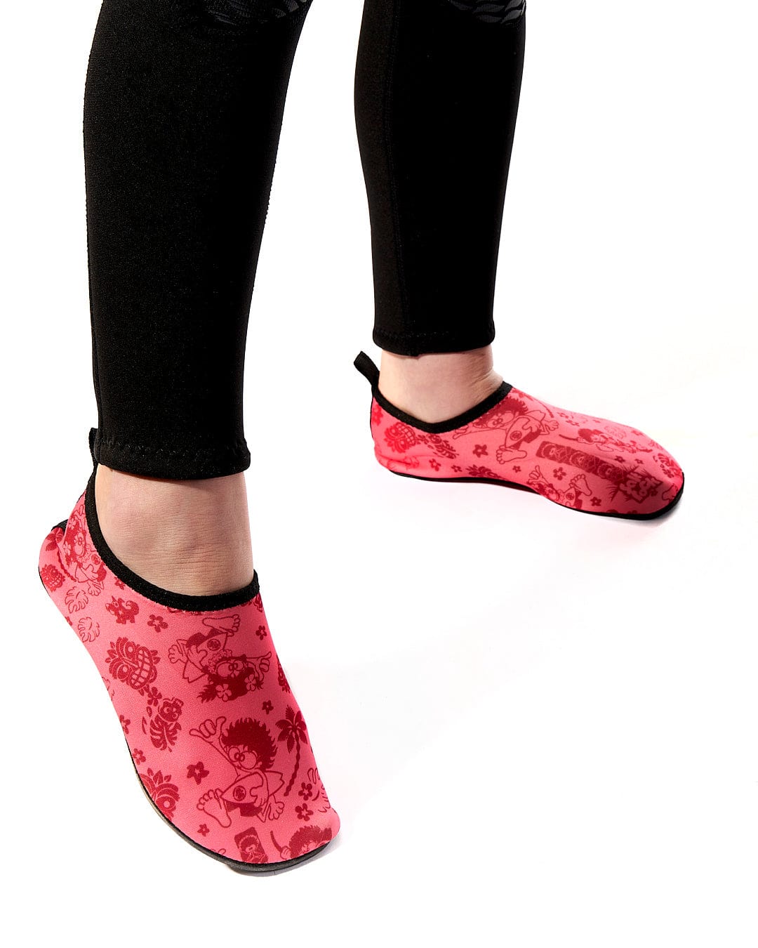 A woman wearing a pair of Tiki Tok - Kids Aqua Shoe - Red slippers by Saltrock.