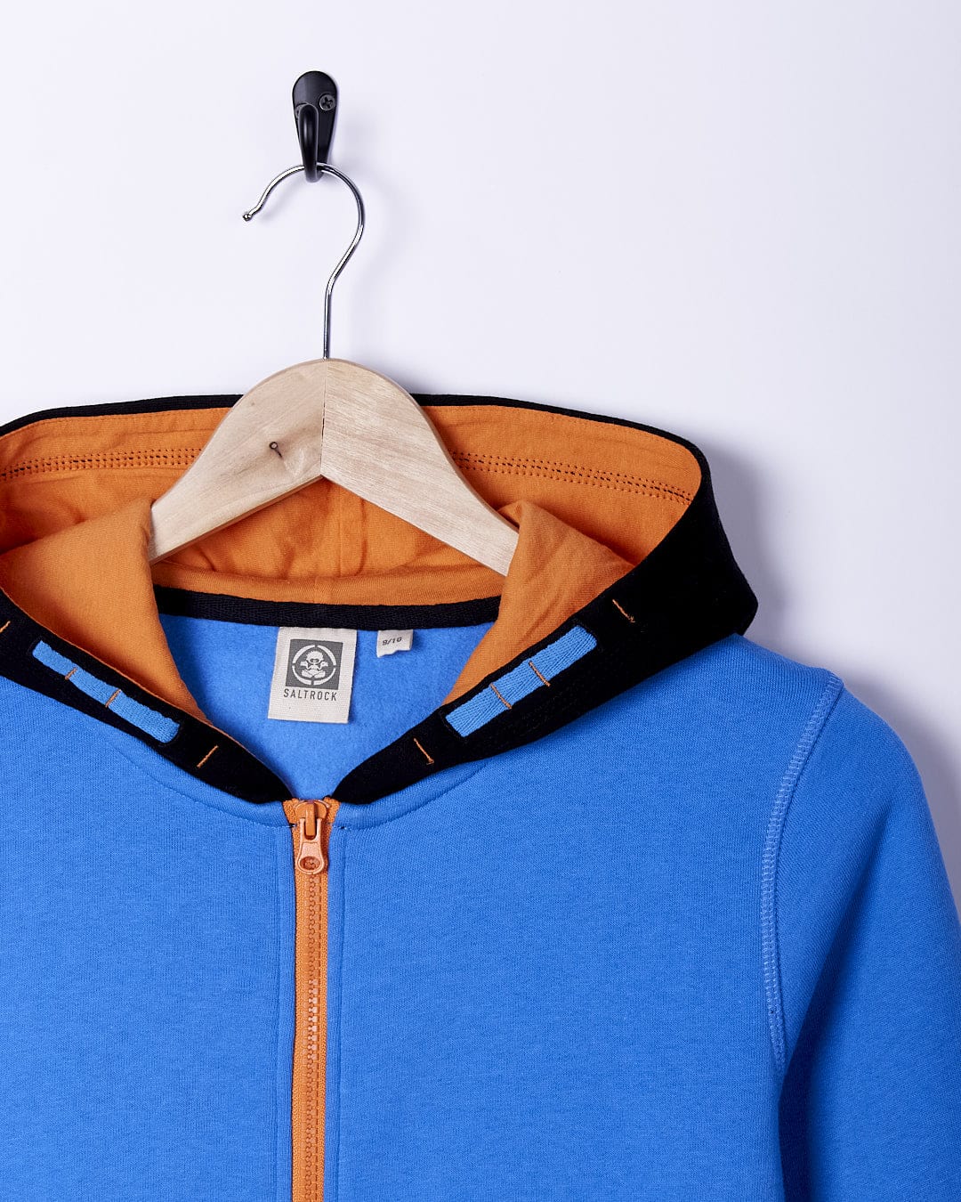 A Saltrock Warp Ride - Kids Zip Hoodie - Blue hanging on a hanger.