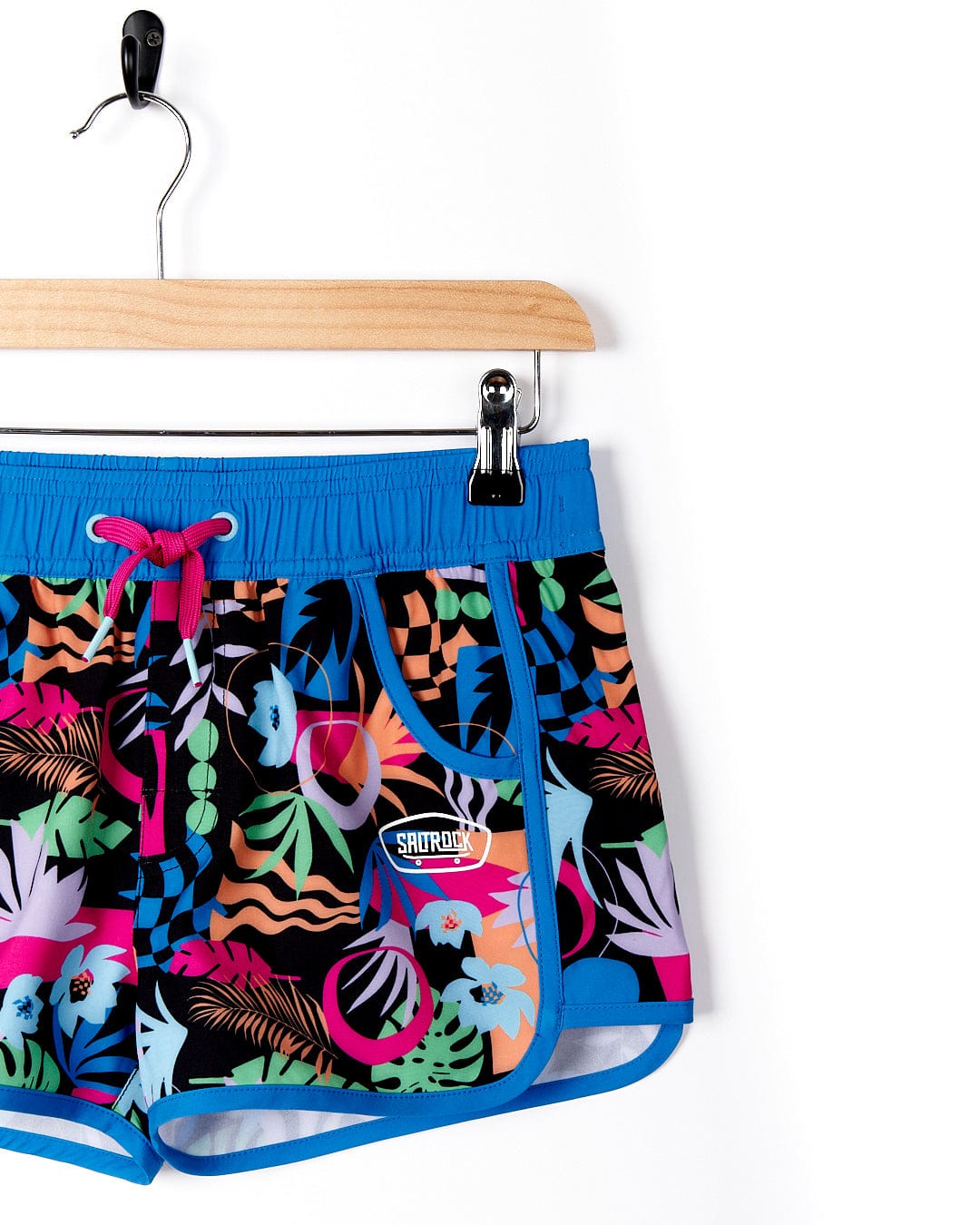 A Saltrock Zephyr - Kids Boardshort - Blue with colorful tropical print.