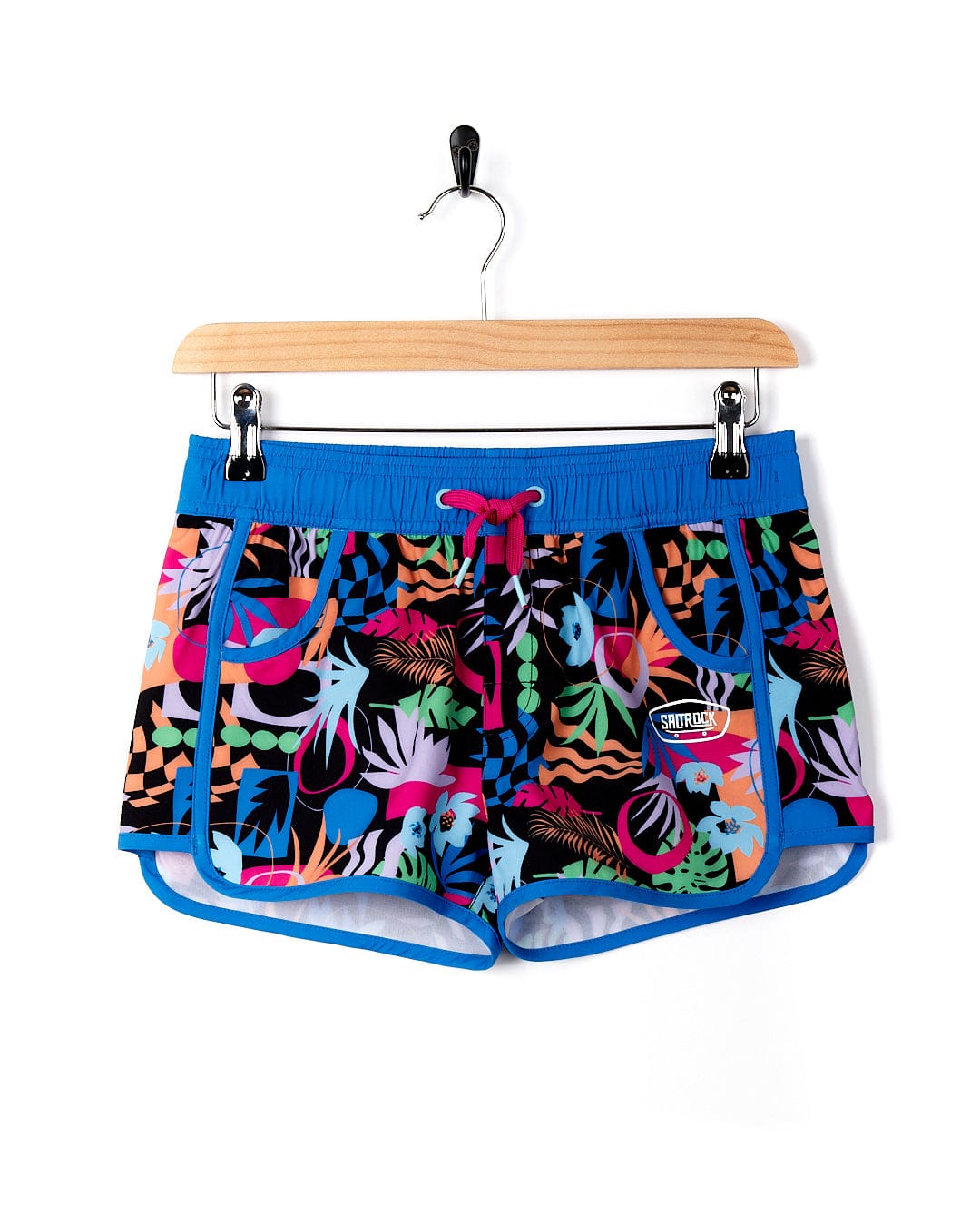 A pair of Saltrock Zephyr - Kids Boardshort - Blue shorts on a swing.
