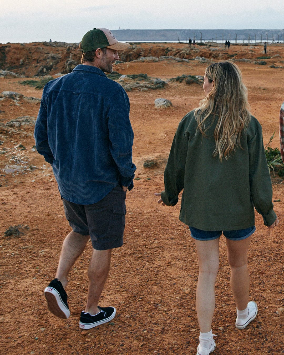 A man in a Saltrock Ace - Mens Long Sleeve Shirt - Blue and a woman walking on a dirt path.