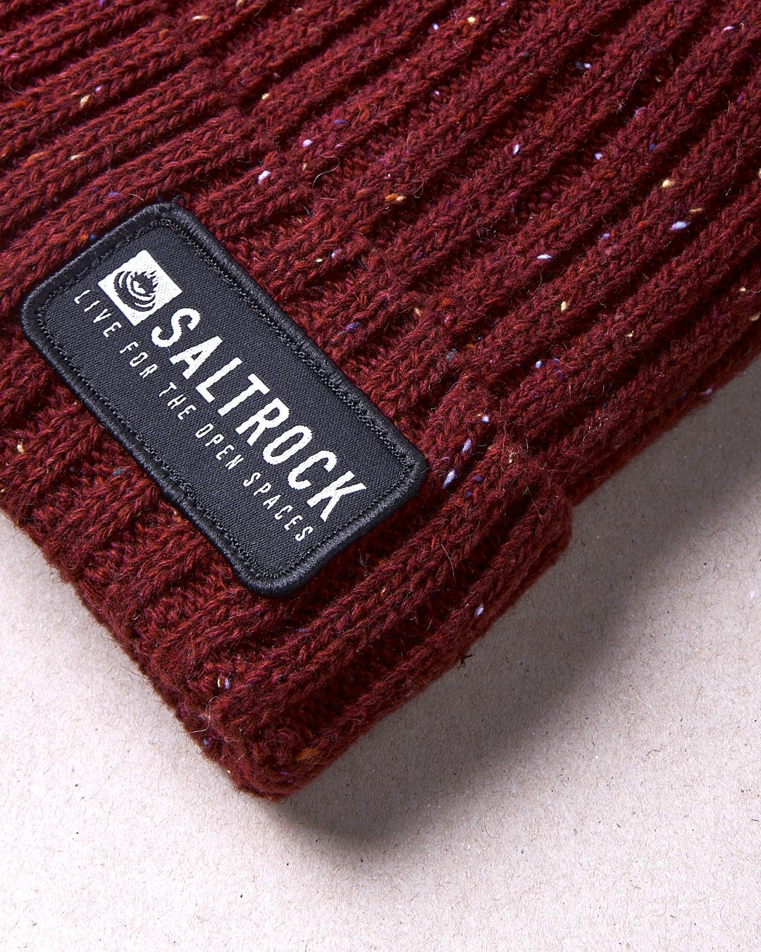 A Saltrock Heritage - Beanie - Red with a label on it.