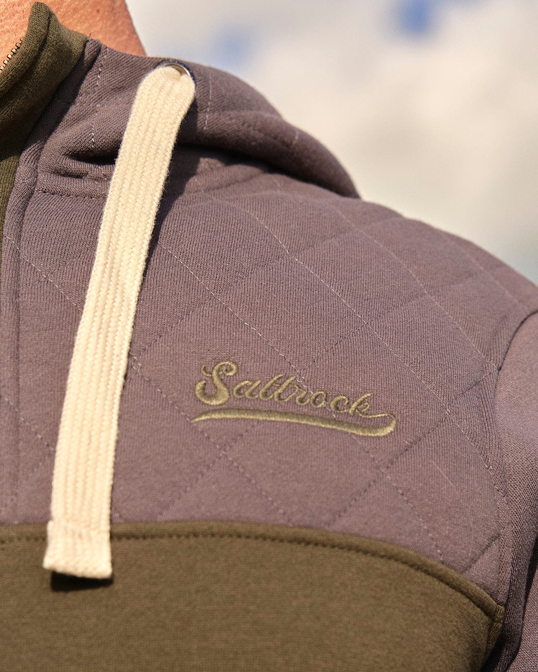 The Saltrock Aiken Mens 1/4 Neck Hoodie in Green provides warmth and comfort with a touch of style, featuring the word "seasox" on the back. Perfect for outdoor activities.