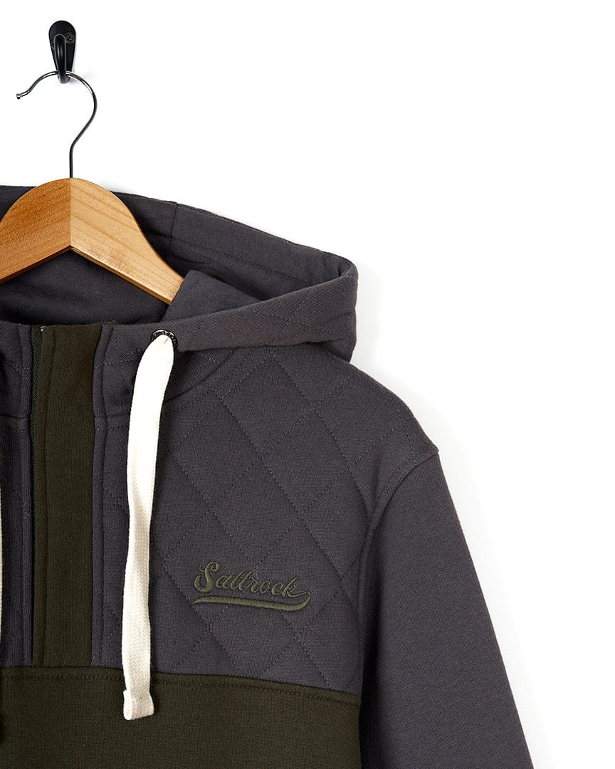 A Saltrock - Aiken Mens 1/4 Neck Hoodie - Dark Grey and olive hoodie hanging on a hanger.