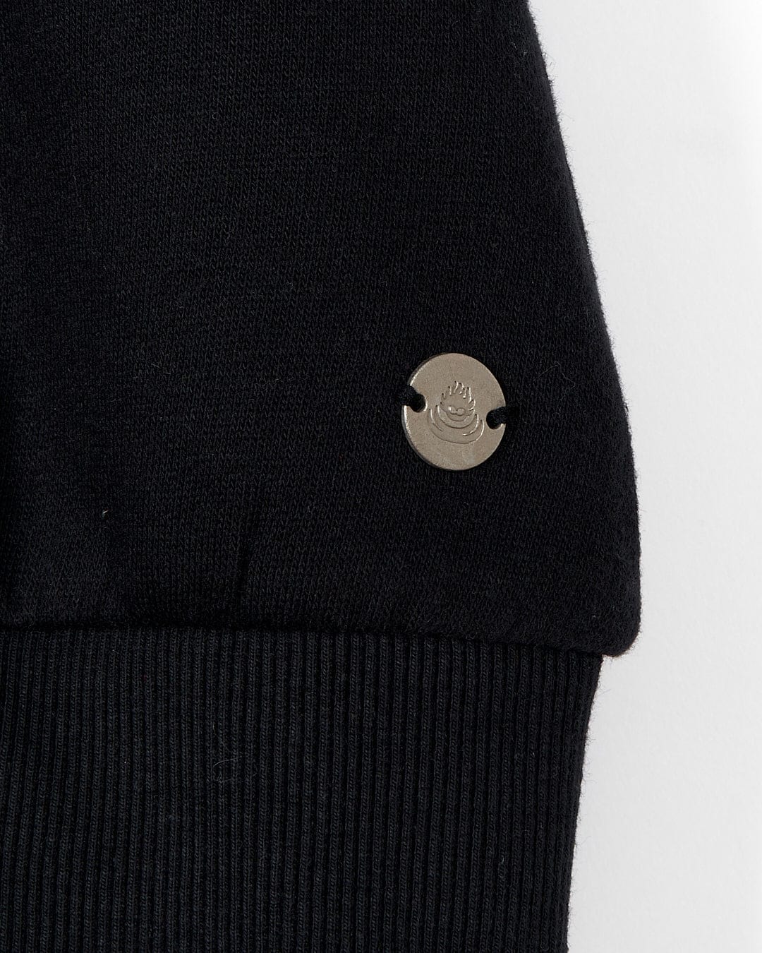 A close up of a Saltrock Alma - Womens Balloon Sleeve Sweat Dress - Black with a metal button.