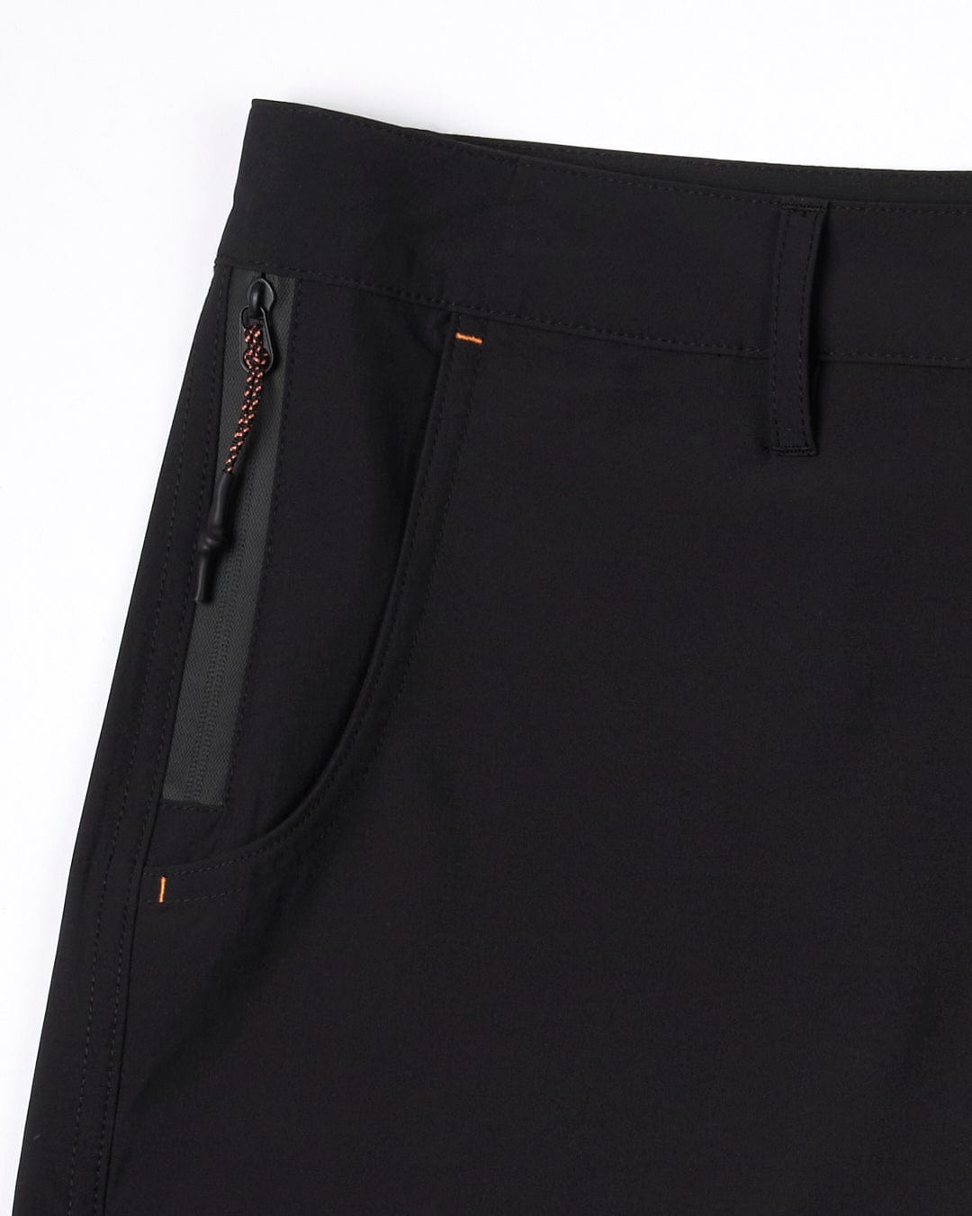 Close-up of a Saltrock Amphibian - Womens Boardshort - Black pocket with zip fastening and an orange stitch detail.