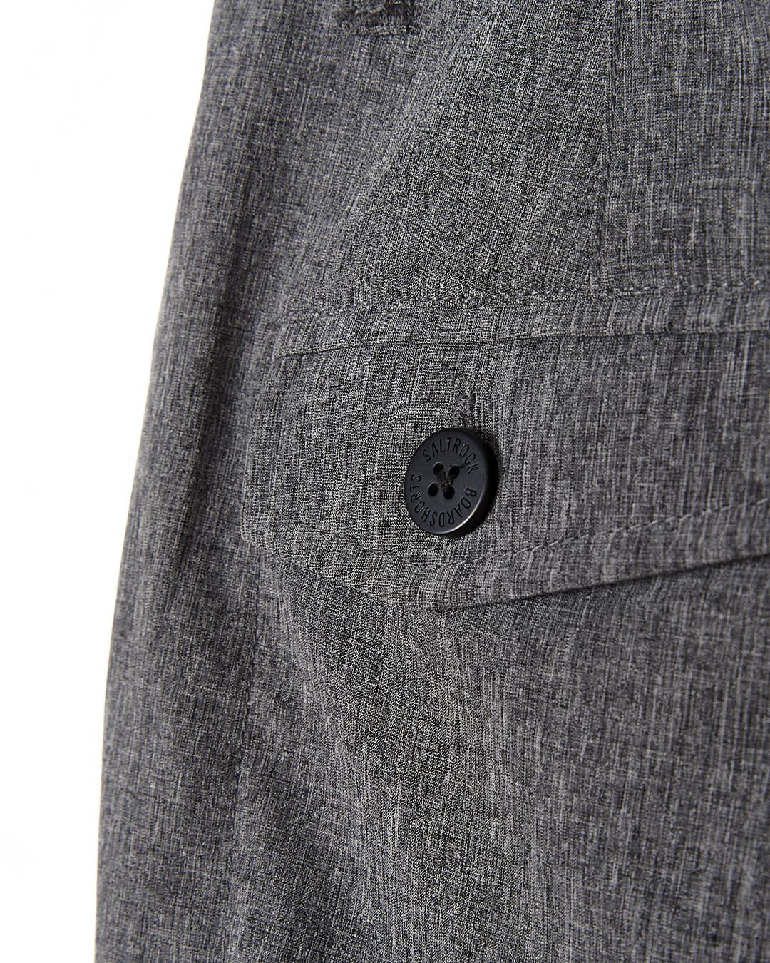 A close up of the button on a Saltrock Amphibian - Kids Boardshorts - Grey linen trouser.