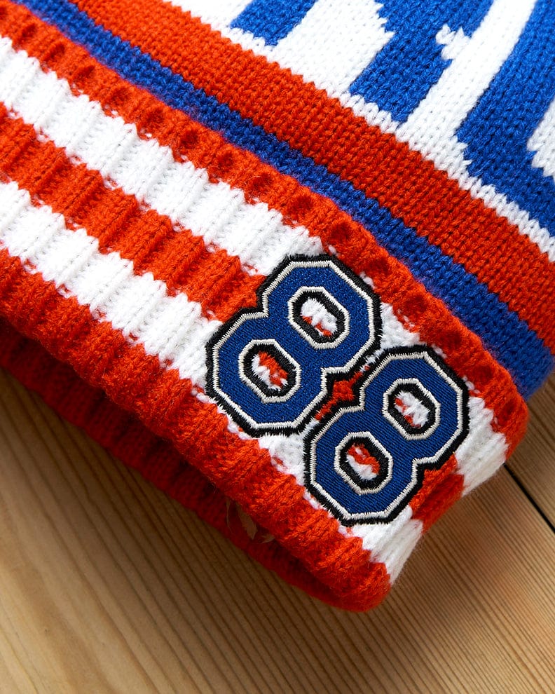 A knitted Apres - Beanie - Blue with the number 88 on it, featuring Saltrock branding.
