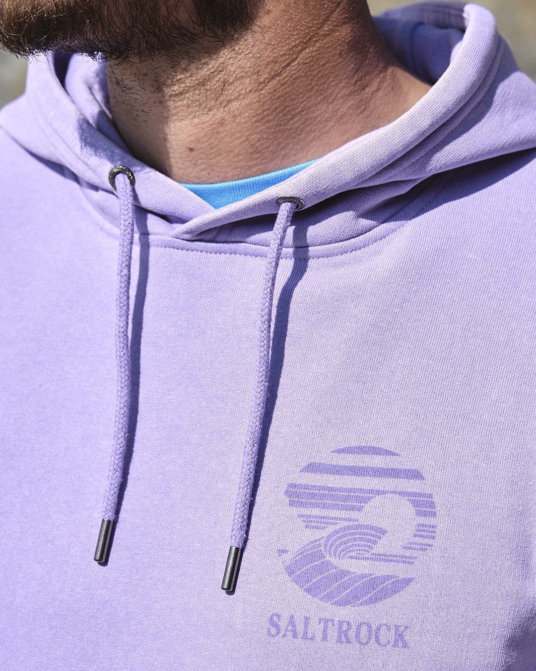 A man wearing a Saltrock Atlantic - Mens Pop Hoodie - Purple.