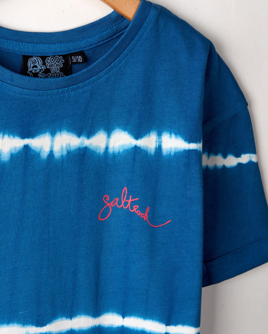 A blue tie-dye Aubrey - Kids T-Shirt Dress - Blue with a white horizontal stripe pattern, made from 100% cotton, featuring a red embroidered Saltrock logo on the chest.
