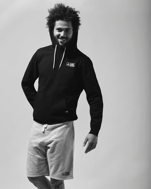 A black and white photo of a man wearing a Saltrock Original - Mens Short in Blue Marl hoodie with draw cords.