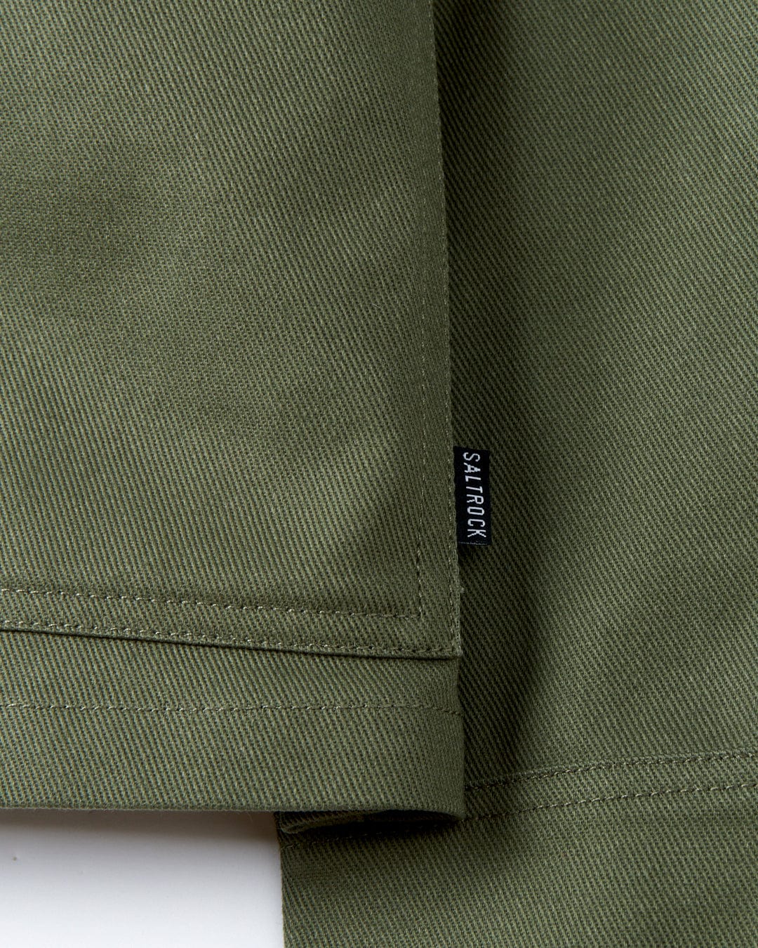 A close up of a Saltrock Barden - Womens Lightweight Utility Jacket in dark green cotton twill fabric.