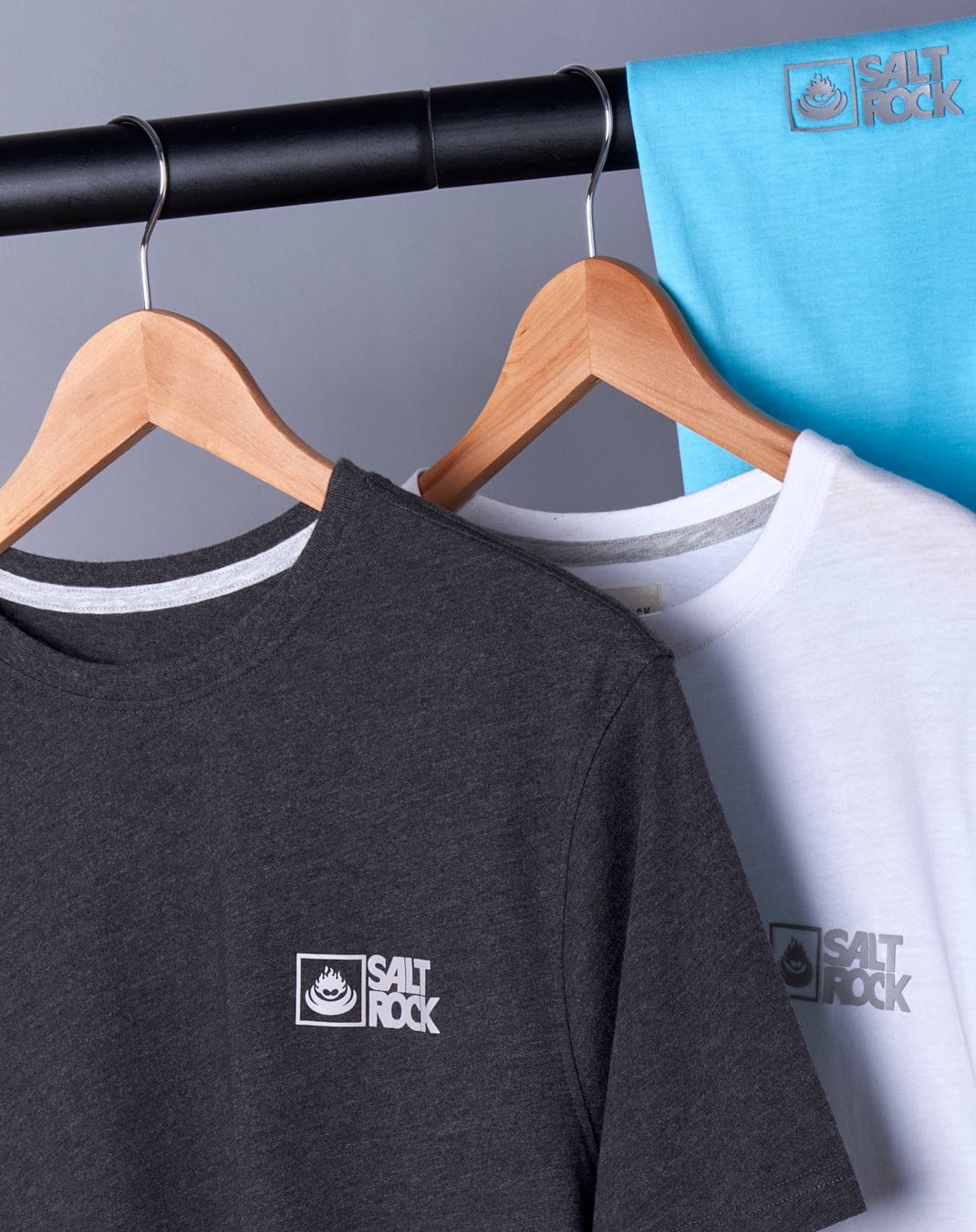 Two Saltrock Corp 20 men's short sleeve t-shirts hanging on a rack, an everyday essential.