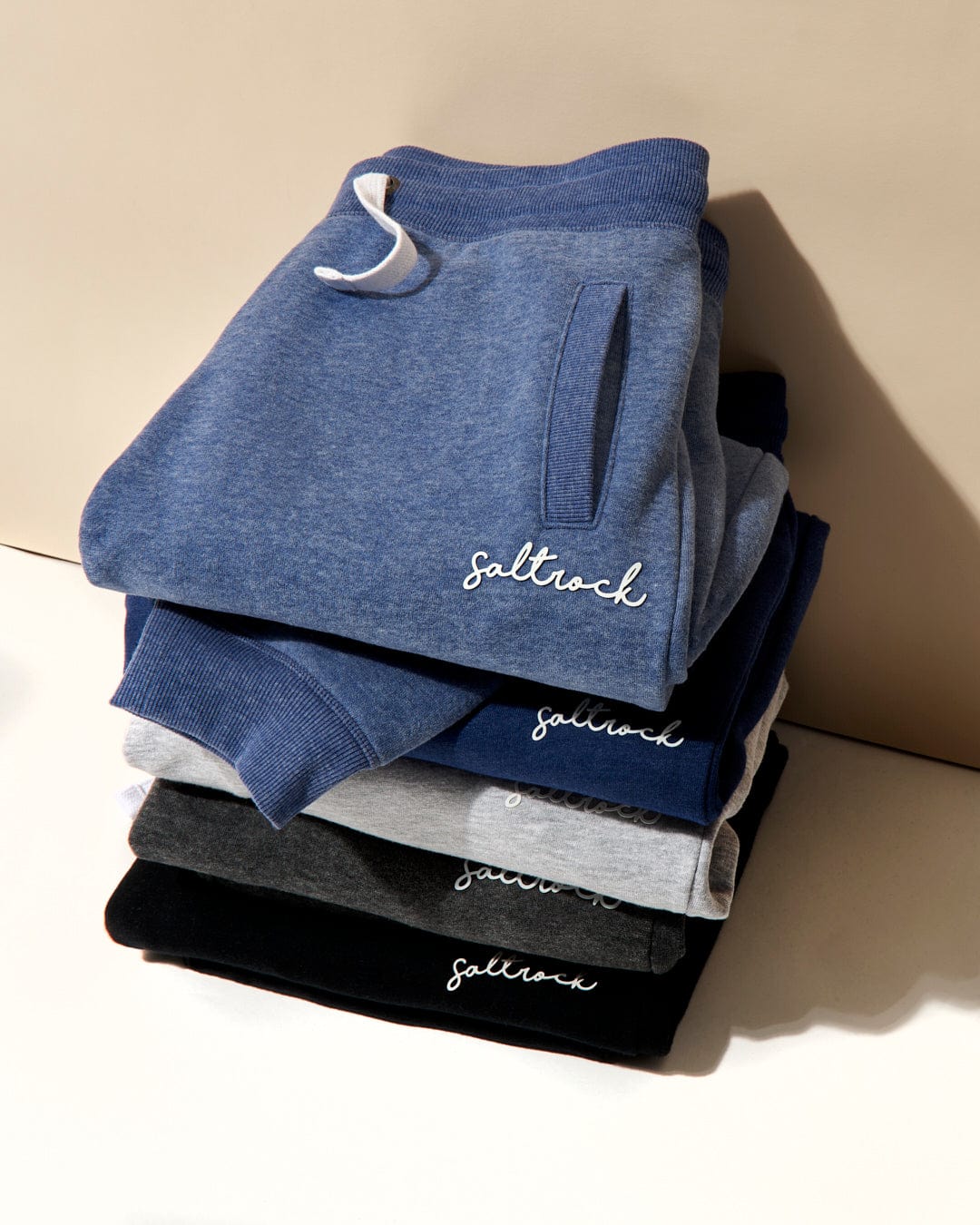 A stack of folded Velator Womens Joggers in Dark Grey with the Saltrock branding visible on the top one.