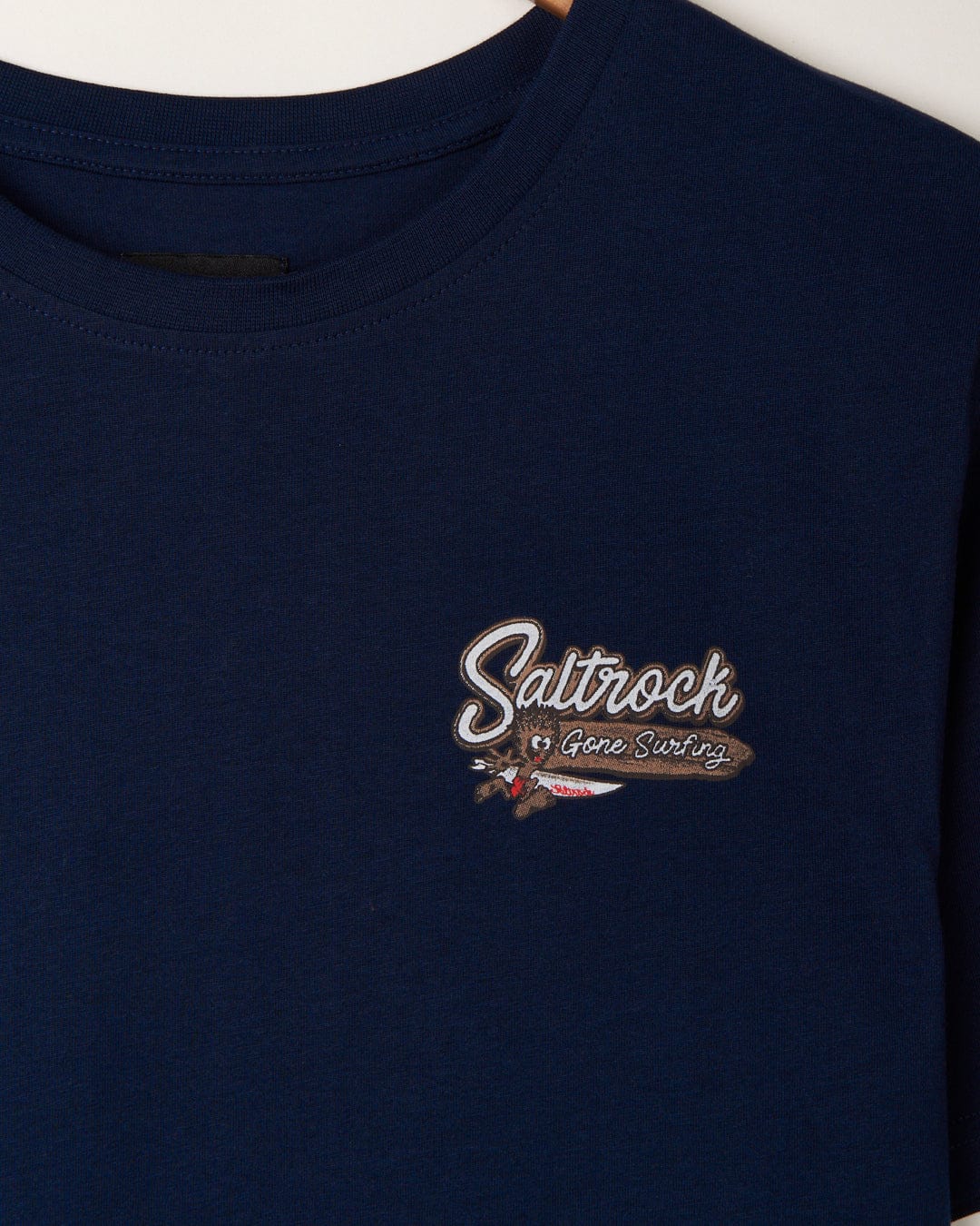 A Beach Signs Cornwall t-shirt with the word Saltrock on it, featuring a peached soft hand feel.